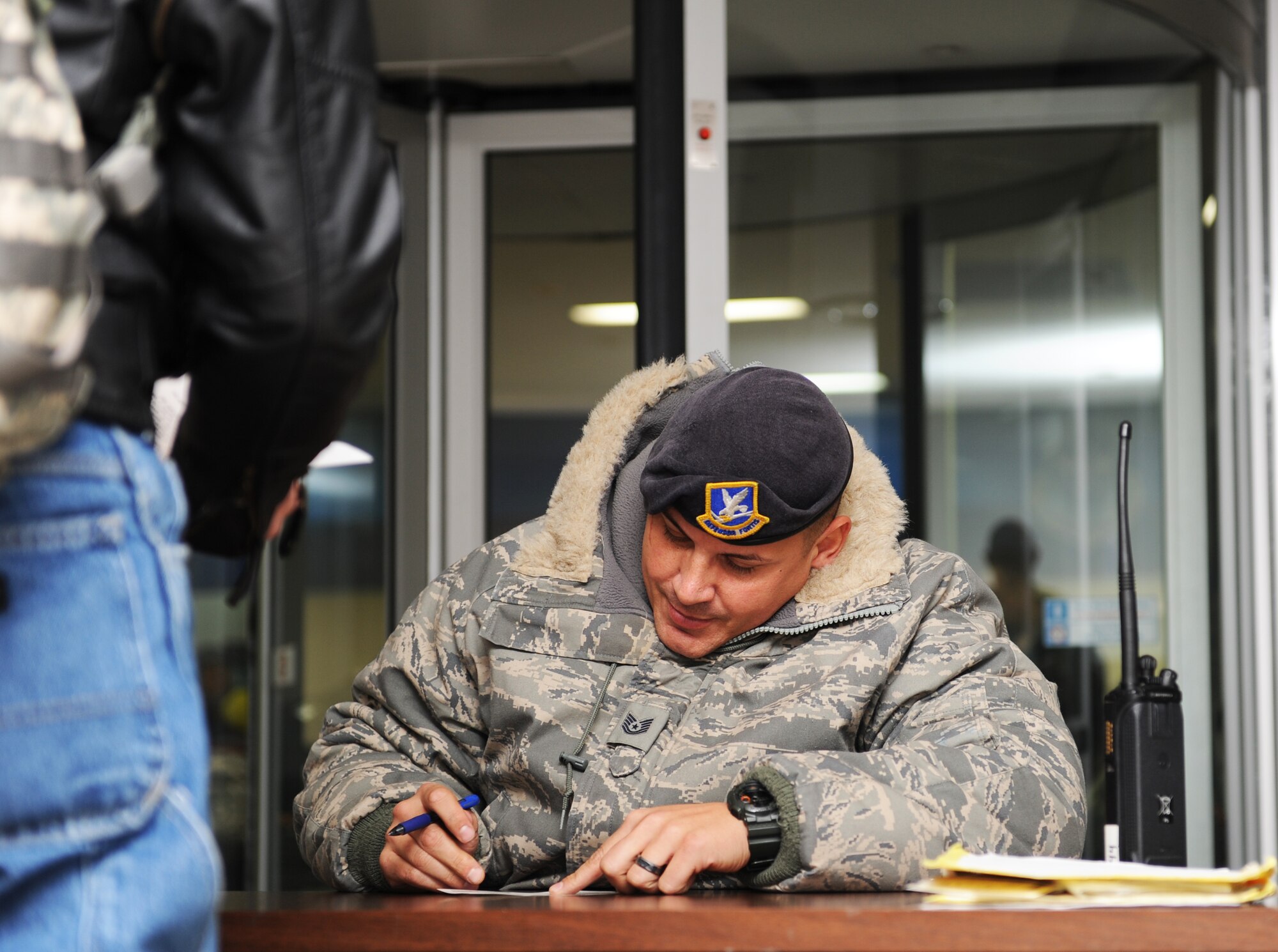 U.S. Air Force Tech. Sgt. Jason Kidd, 35th Security Forces Squadron customs officer, processes more than 240 unexpected passengers through customs at Misawa Air Base, Japan, Dec. 4, 2012. Kidd verified the passenger’s had the proper identification and had their Government of Japan Disembarkation forms completed. (U.S. Air Force photo by Airman 1st Class Kia Atkins)