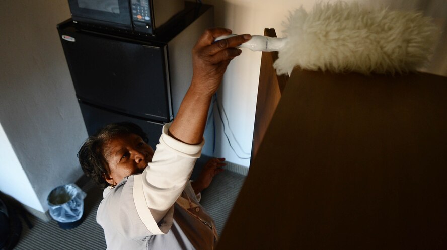 Geraldine Williams, Carolina Pines Inn housekeeper, dusts a dresser at Shaw Air Force Base, S.C., Nov. 27, 2012. Williams is the Shaw Spotlight for the week of Dec. 3 to Dec. 7. (U.S. Air Force photo by Airman Nicole Sikorski/Released) 