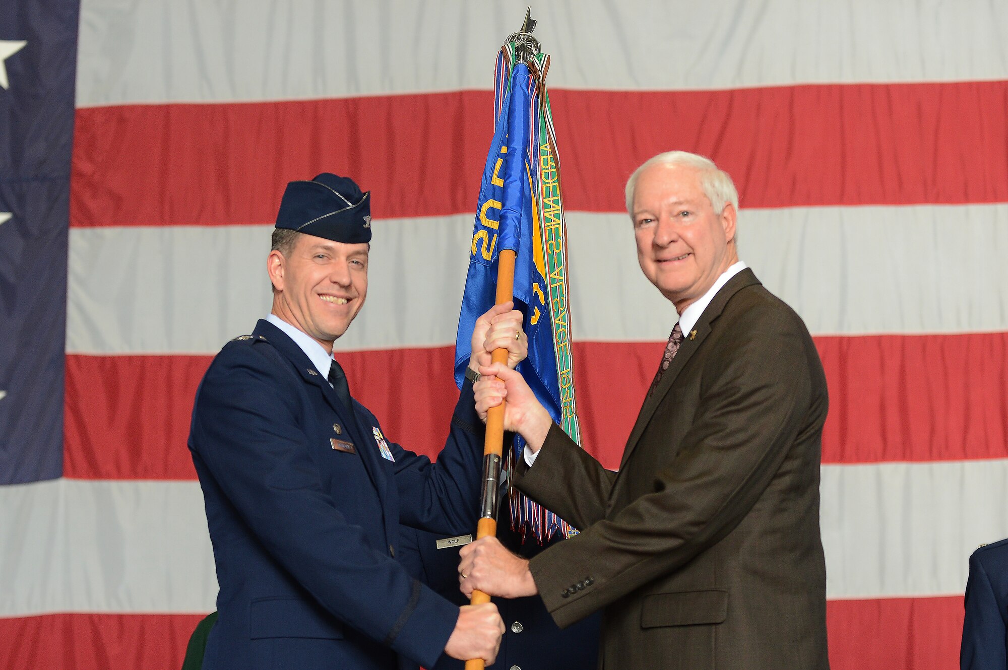U.S. Air Force Col. Shaun McGrath, 20th Operations Group commander, awards Cliff Goodwin the title of honorary commander in Hangar 1200, Shaw Air Force Base, S.C., Nov. 30, 2012.  The honorary commander program is intended to strengthen the bonds between Shaw and its Sumter neighbors.   (U.S. Air Force photo by Airman Nicole Sikorski/Released)