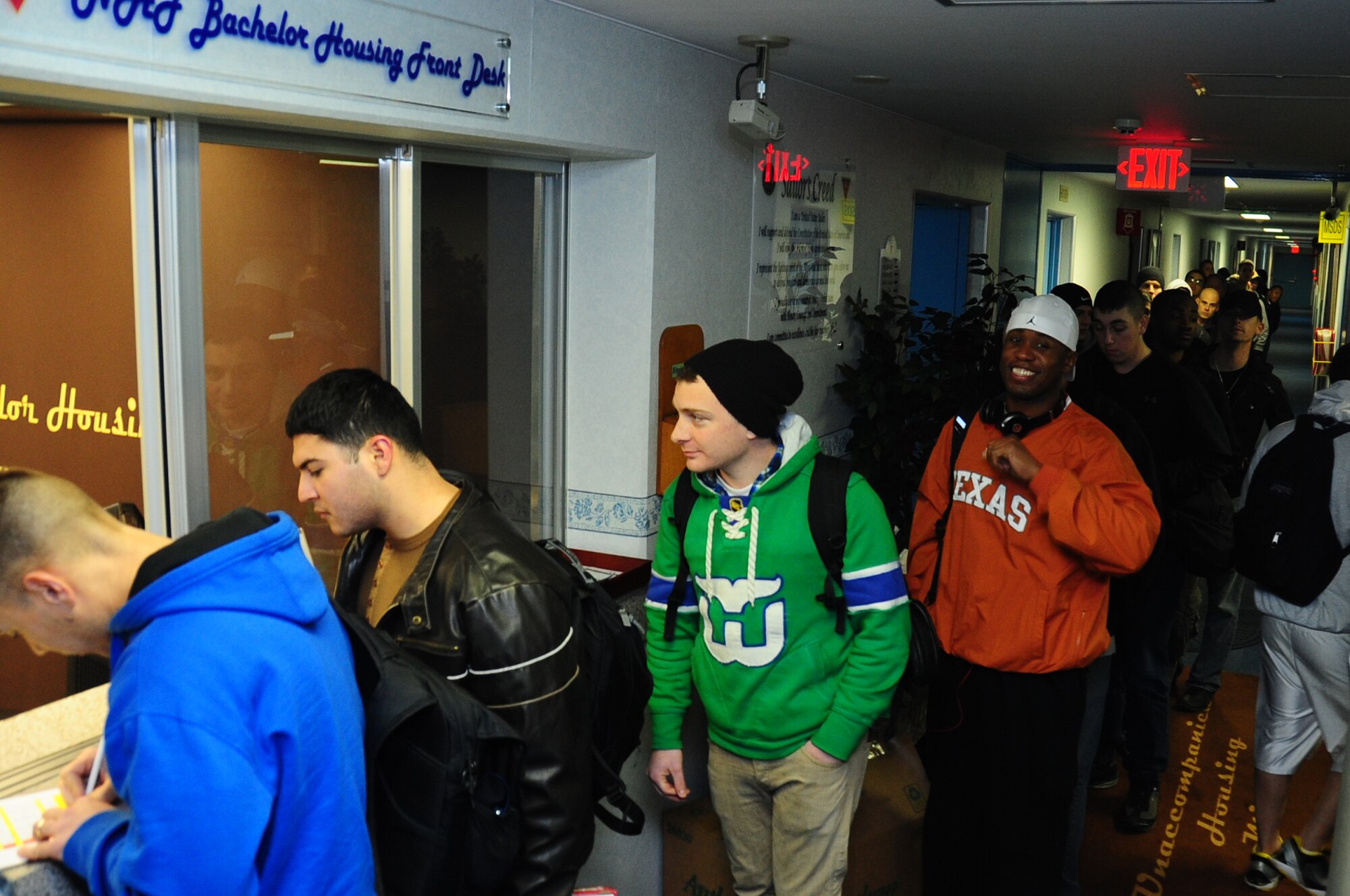 Single and unaccompanied patriot express passengers check into their rooms, provided for them by the Navy Gateway Inn Suite, after their plane experienced mechanical issues and unexpectedly return to Misawa Air Base, Japan, Dec. 4, 2012.  The base was in the middle of an operational readiness exercise when the Command Post was notified of the planes return.  (U.S. Air Force photo by Staff Sgt. April Quintanilla)
