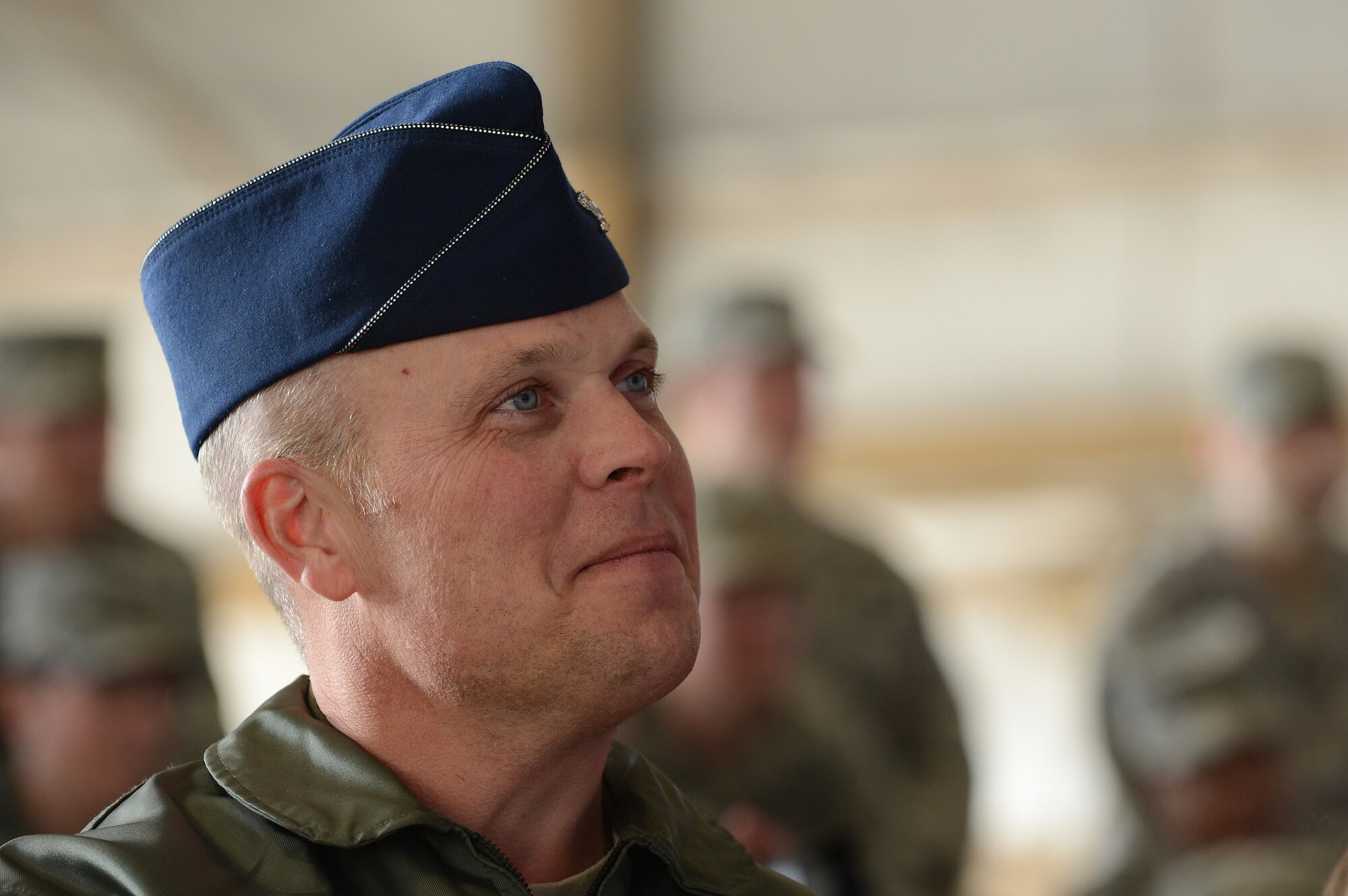 U.S. Air Force Col. Lance Kildron, 20th Fighter Wing vice commander, listens to Fowler Cary speak after assuming the title of lifetime honorary commander in Hangar 1200, Shaw Air Force Base, S.C., Nov. 30, 2012.  The honorary commander program is intended to strengthen the bonds between Shaw and its Sumter neighbors.  (U.S. Air Force photo by Airman Nicole Sikorski/Released)