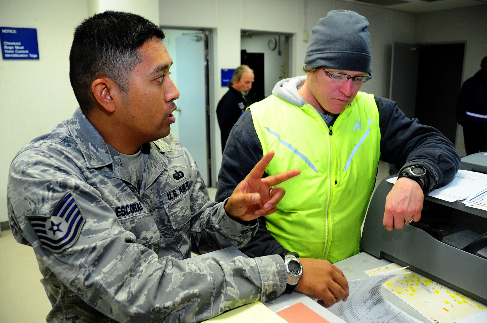 U.S. Air Force Tech. Sgt. Kenneth Escobar, 35th Force Support Squadron NCO in charge of lodging, and Frank McManus, World Airways, work together to find lodging for more than 240 unexpected passengers at Misawa Air Base, Japan, Dec. 4, 2012.  The base was in the middle of an operational readiness exercise when base leadership was notified of the planes arrival. (U.S. Air Force photo by Staff Sgt. April Quintanilla)
