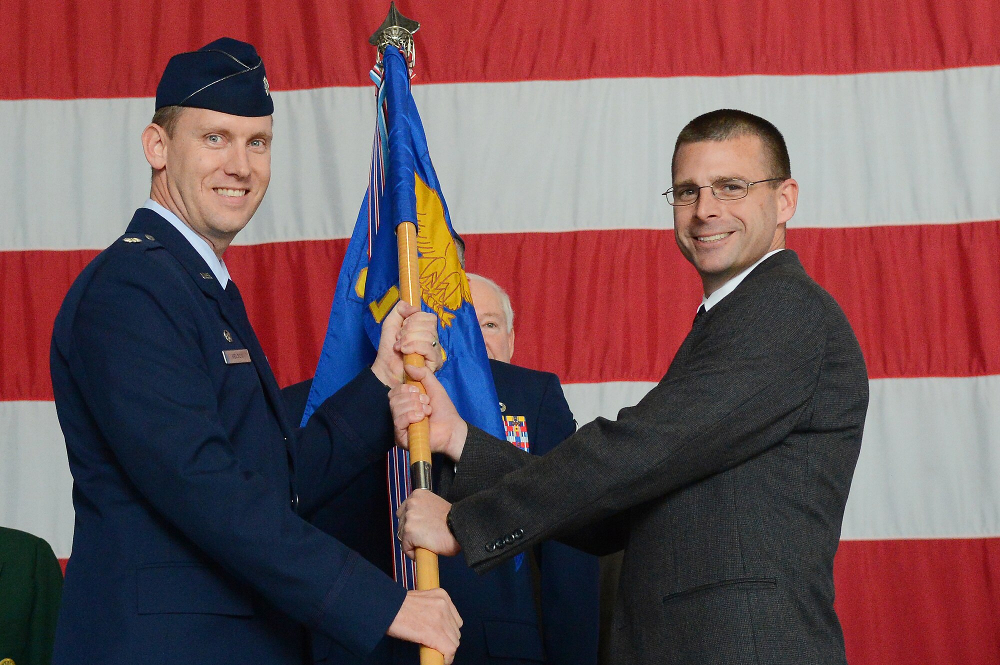 U.S. Air Force Lt. Col. Richard Nelson, 20th Operational Support Squadron commander, awards Donny Hines the title of honorary commander in Hangar 1200, Shaw Air Force Base, S.C., Nov. 30, 2012. The honorary commander program is intended to strengthen the bonds between Shaw and its Sumter neighbors.  (U.S. Air Force photo by Airman Nicole Sikorski/Released)