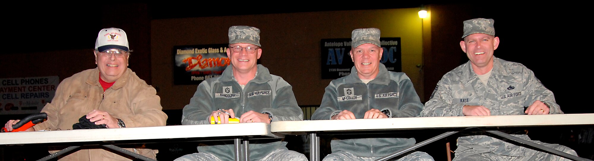 From left to right: Dennis Shoffner, 412th Test Wing Public Affairs, Community Relations chief; Chief Master Sgt. Brian Randolph, 412th Test Wing command chief; Chief Master Sgt. Christopher McCollor, Air Force Test Center command chief; and Chief Master Sgt. Allen Kale, 412th Aircraft Maintenance Squadron.  The three chiefs served as judges during the Rosamond Parade of Lights Dec. 1. Rosamond resident Shoffner emcee'd the event. (U.S. Air Force photo by Laura Mowry)