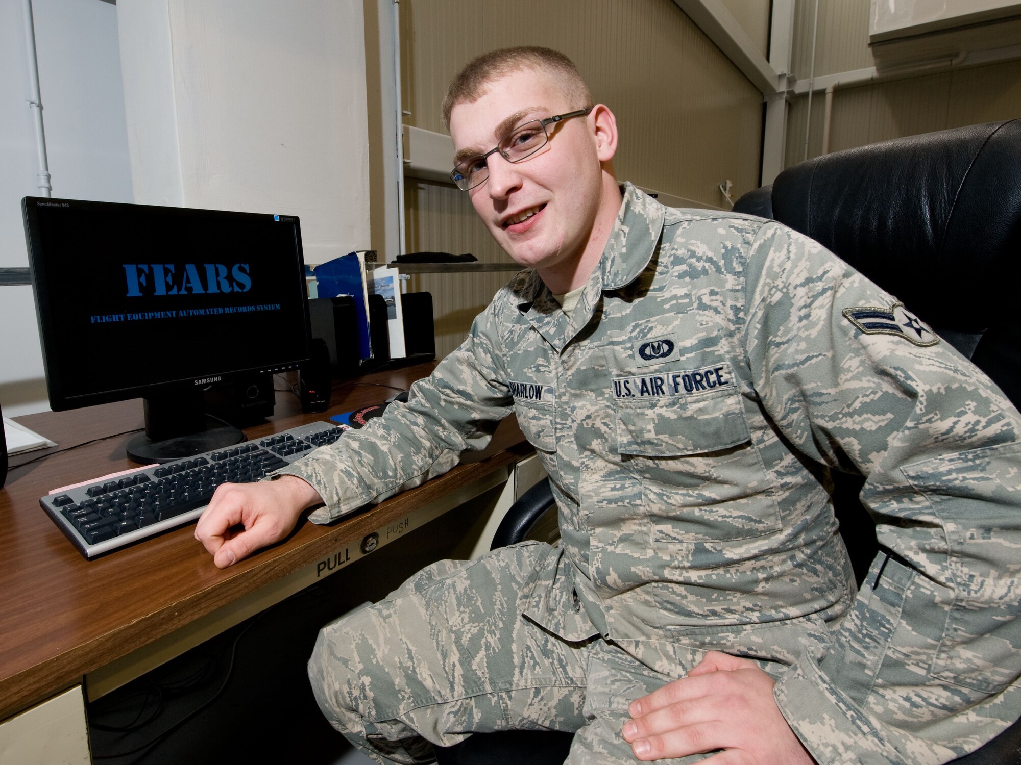 Airman 1st Class Chris Sharlow, 436th Operations Support Squadron Aircrew Flight Equipment journeyman, poses for a photo at Dover Air Force Base, Del., on Nov. 30, 2012. He is the creator of a new computer program used to easily track thousands of accountable aircrew equipment items. Sharlow's program is known as the Flight Equipment Automated Records Systems (FEARS) and is being used to ensure tracking and on-time inspections of items critical to safe, efficient mission accomplishment. (U.S. Air Force photo by Greg L. Davis)