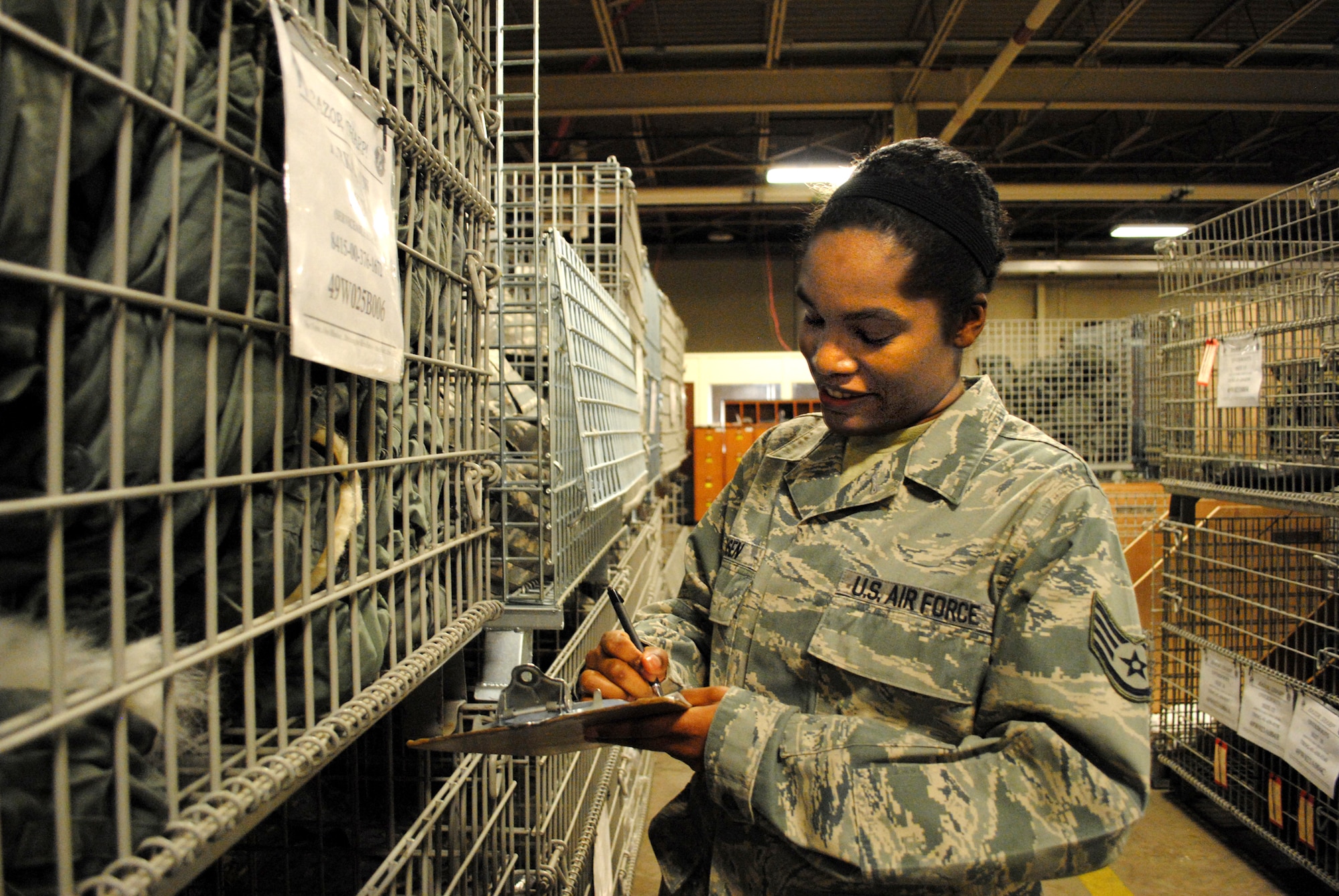 Staff Sgt. Adrian Jensen, an individual protective equipment NCO with the 319th Logistics Readiness Squadron, takes inventory of a cage filled with thick winter coats Nov. 26, 2012, at the 319th LRS mobility equipment depot on Grand Forks Air Force Base, N.D.  Along with keeping inventory, Jensen also periodically inspects mission-essential items such as parkas, which help Airmen stay warm and work in severe cold weather conditions that sometimes reach subzero temperatures. (U.S. Air Force photo/Senior Airman Luis Loza Gutierrez) 