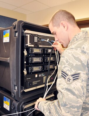 Senior Airman Thomas Roland, 94th Communications Squadron communications specialist, prepares a Joint Incident Site Communication Capability (JISCC) satellite system for operation. The squadron maintains the capability of JISCC deployment within 48 to 72 hours notice hours. (U.S. Air Force photo/Senior Airman Christina Bozeman)