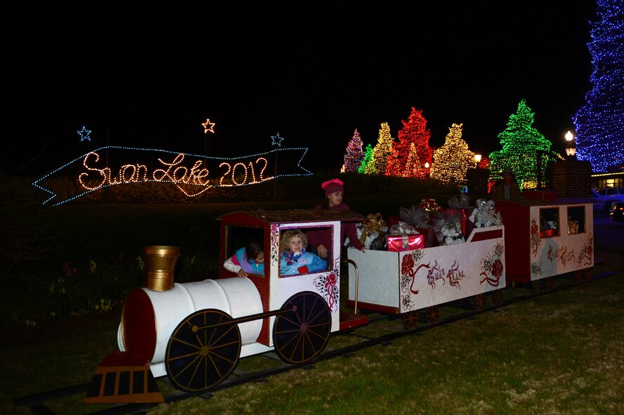 Children play on a toy train during the Fantasy of Lights celebration at Swan Lake in Sumter, S.C., Dec. 1, 2012. Sumter community members not only created many of the light designs around Swan Lake, but also spent weeks setting up all the lights. (U.S. Air Force photo by Airman 1st Class Krystal M. Jeffers/Released) 

