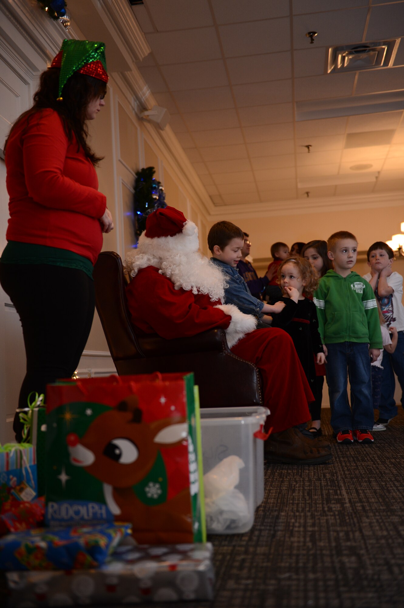 Children line up to sit on Santa?s lap at Carolina Skies Conference and Club at Shaw Air Force Base, S.C., Dec. 4, 2012. Santa was at the club as part of an event, called, ?Breakfast with Santa.? (U.S. Air Force photo by Airman First Class Krystal M. Jeffers/Released)