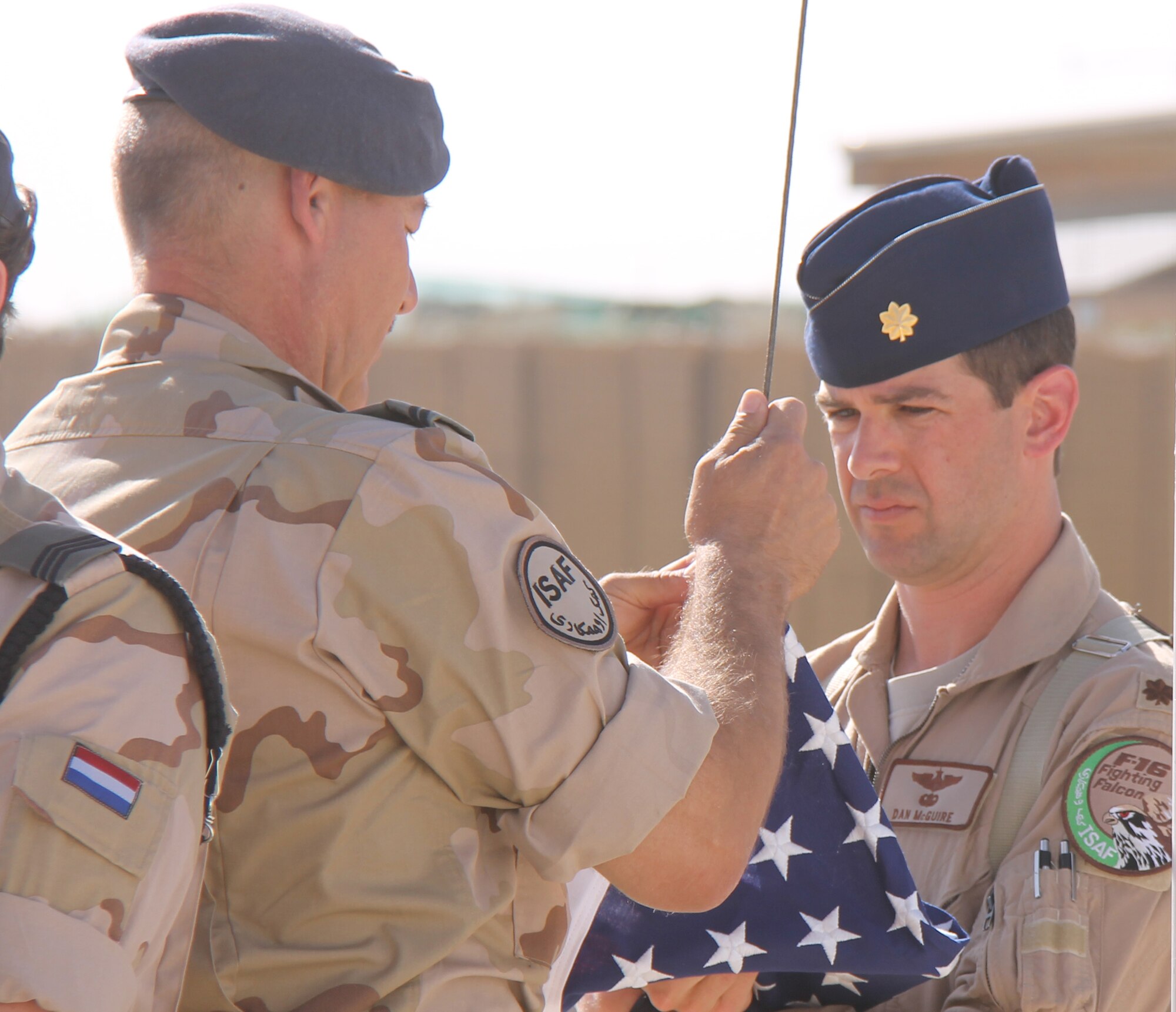 Maj. Dan McGuire, an F-16 exchange pilot who was assigned to the 312th
Tactical Fighter Squadron at Volkel Air Base in the Netherlands, prepares to
fly a U.S. flag  in May 2012 at his base in Mazar-e-Sharif, Afghanistan.
McGuire, who participated in the Air Force Personnel Exchange Program,
deployed for four months with the Dutch Air Task Force, a detachment of the
Royal Netherlands Defense. He flew missions throughout most of Afghanistan
supporting the International Security Assistance Force (ISAF) and Operation
Enduring Freedom. (Photo by Sgt. Maj. Ruud Medema/Royal Netherlands Air
Force)
