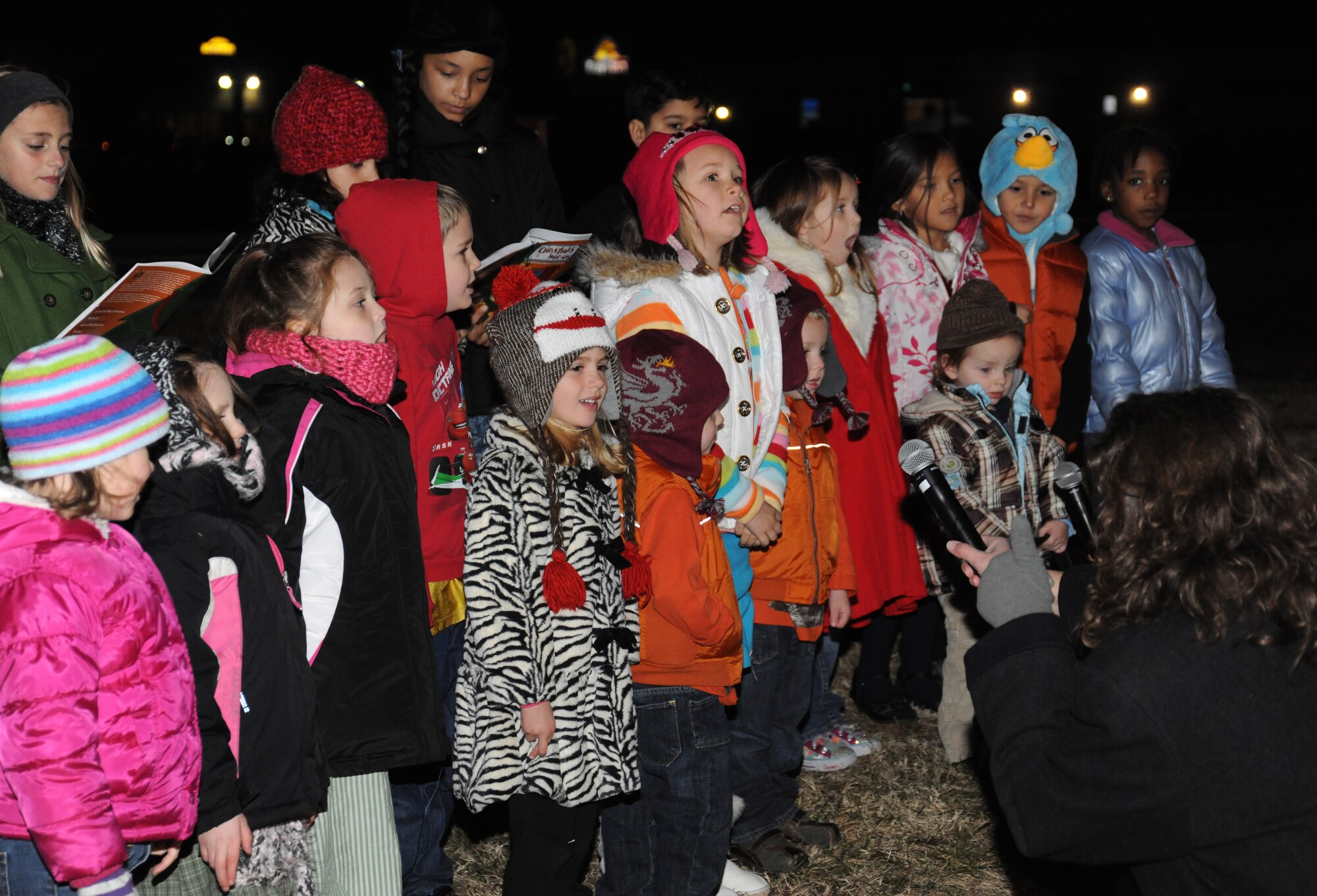 Children gather to sing Christmas carols during the Christmas Tree and Menorah Lighting Ceremony at Chapel One, Nov. 29, 2012. The lighting of the tree and menorah is an annual event that consists of singing, menorah and tree lighting, prayer and a visit from Santa and Mrs. Claus. (U.S. Air Force photo/Airman 1st Class Erin O’Shea) 