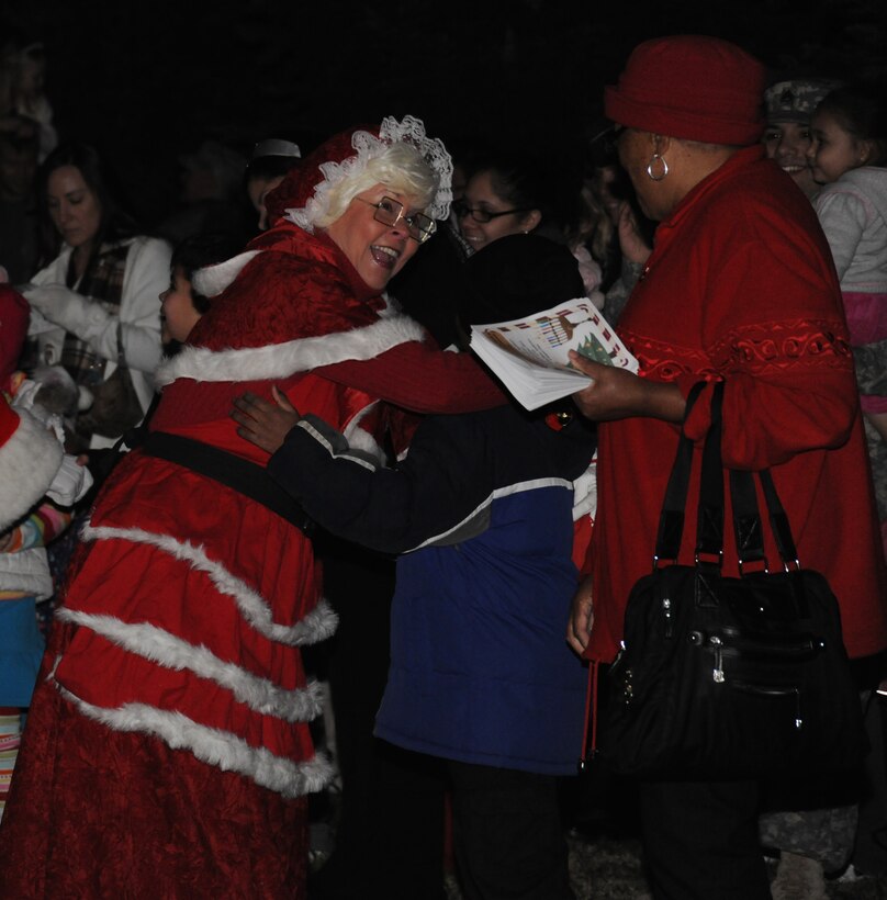 Mrs. Claus greets families upon arrival to the Christmas Tree and Hanukah Menorah Lighting Ceremony at Chapel One, Nov. 29, 2012. The lighting of the tree and menorah is an annual event that consists of singing, menorah and tree lighting, prayer and a visit from Santa and Mrs. Claus. (U.S. Air Force photo/Airman 1st Class Erin O’Shea)  