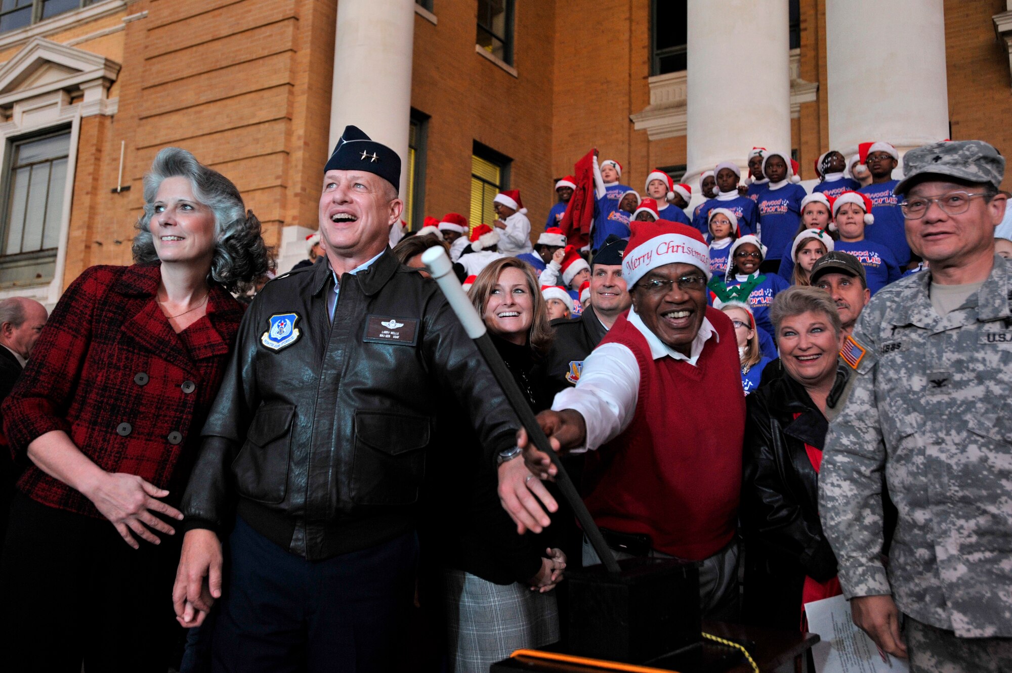 U.S. Air Force Maj. Gen. Lawrence Wells, 9th Air Force commander, and his wife Kathy Wells (left), and Eugene Baten, chairman, Sumter County Council, (center), along with other military officials flip the switch to light the Sumter Christmas tree on the lawn of the Sumter Courthouse, Nov. 30, 2012, Sumter S.C. The annual ceremony brought about the holiday spirit as several elementary, junior high, and high school choirs performed Christmas carols for those who gathered at the courthouse to witness the celebration. (U.S. Air Force photo by Staff Sgt. Kenny Holston/Released)
