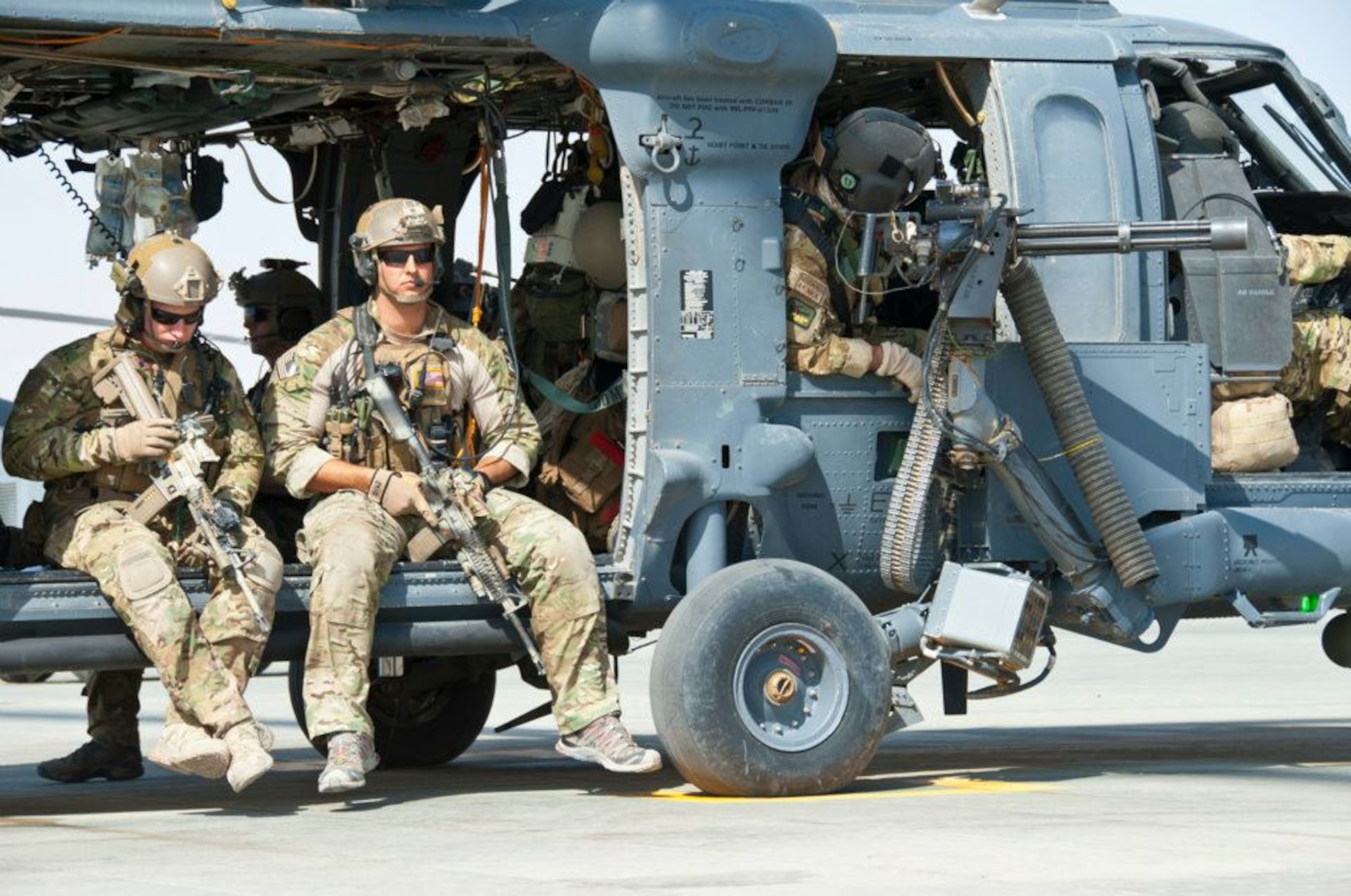 Staff Sgt. Brandon Forshaw (right), a Reserve pararescueman with the 308th Rescue Squadron, part of the 920th Rescue Wing at Patrick Air Force Base, Fla., sits on an HH-60G Pave Hawk helicopter during a deployment to Afghanistan in late 2011. (Courtesy photo)