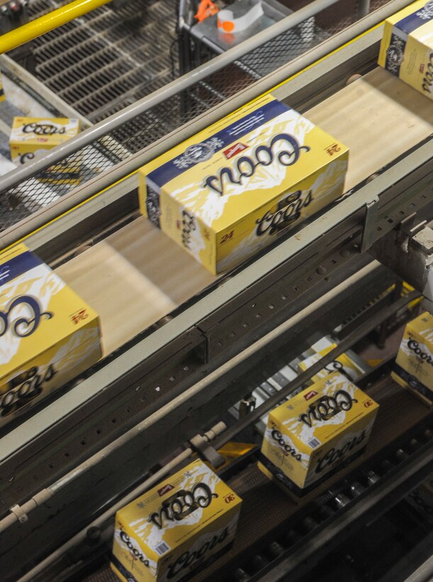 GOLDEN, Colo. – Packs of Coors travel on a conveyer belt Nov. 29, 2012, at the Miller Coors Brewery. The brewery makes 10 to 12 million cans of beer per day. The packaging station is just one step in the brew process that tourists are able to observe during a self-paced tour. (U.S. Air Force photo by Senior Airman Christopher Gross)