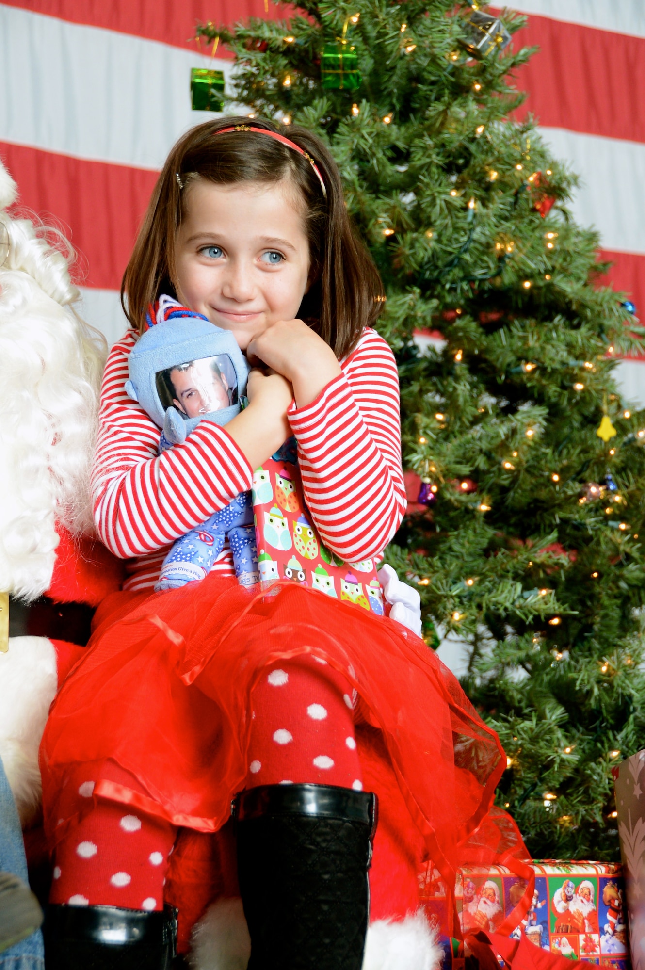 Izzy Vargas, daughter of U.S. Air Force Lt. Col. Johnny Vargas, 77th Fighter Squadron commander, sits with Santa at the 20th Operations Group Children's Holiday Party, Shaw Air Force Base, S.C. Dec. 1, 2012. (U.S. Air Force photo by Capt. Ann Blodzinski/ Released)