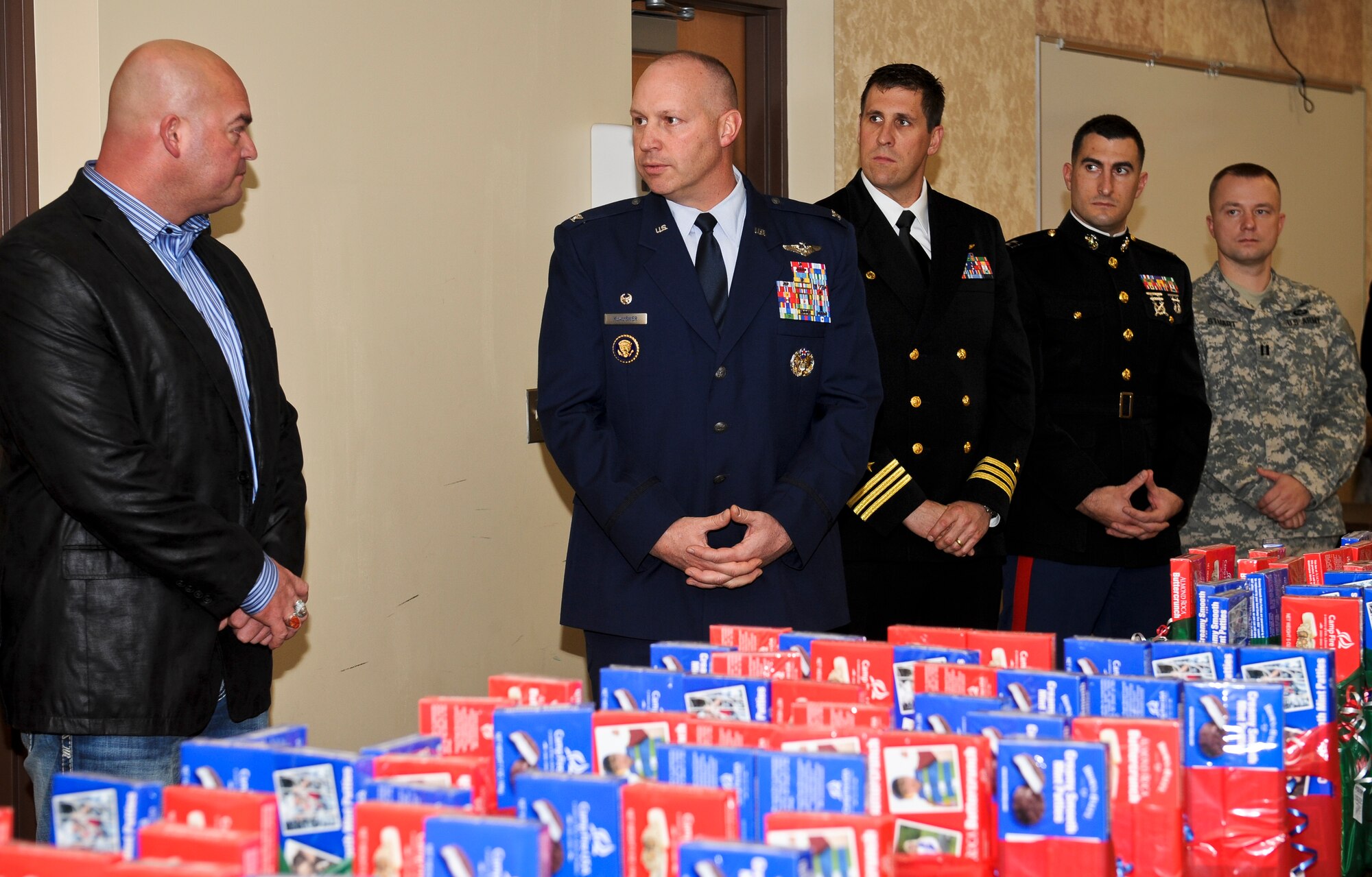 A representative from the Kalispell Tribe speaks with Col. Konrad Klausner and various other U.S. military leaders in the community as he presents gifts cards for troops by Operation Spokane Heroes and Northern Quest Casino and Resort as part of their annual contribution to needy military families in the area Nov. 28, 2012. Klausner is the 92nd Mission Support Group commander. (U.S. Air Force photo by Senior Airman Benjamin Stratton)