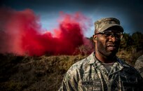 Tech. Sgt. Denoris Mickle, 1st Combat Camera Squadron photographer, walks back to the 628th Explosive Ordnance Disposal building after performing grenade training Nov. 30, 2012, at Joint Base Charleston – Air Base, S.C. Mickle and several other Airmen practiced throwing grenades and smoke grenades to keep their deployment checklist up to date. (U.S. Air Force photo/ Senior Airman Dennis Sloan)