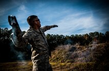 Staff Sgt. David Alderete, 1st Combat Camera Squadron maintenance, prepares to throw a Ground Burst Simulator grenade into a ditch during Combat Readiness Training with the 628th Explosive Ordnance Squadron Nov. 30, 2012, at Joint Base Charleston – Air Base, S.C. Airmen attend an hour-long class to review safety procedures when handling grenades. (U.S. Air Force photo/ Senior Airman Dennis Sloan)