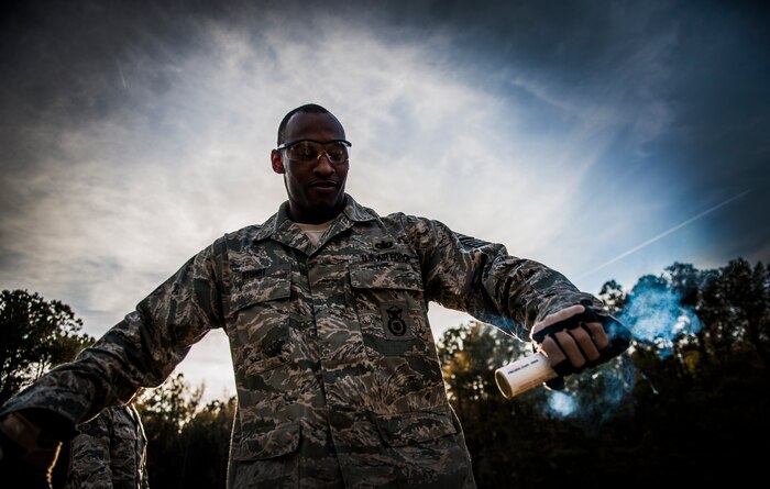 Tech. Sgt. Rudolph Stuart, 628th Security Forces Squadron noncommissioned officer in charge, pulls the rip cord on a Ground Burst Simulator grenade during Combat Readiness Training with the 628th Explosive Ordnance Squadron Nov. 30, 2012, at Joint Base Charleston – Air Base, S.C. Airmen attended an hour-long class to review safety procedures when handling grenades.  (U.S. Air Force photo/ Senior Airman Dennis Sloan)