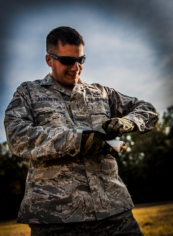 Staff Sgt. David Alderete, 1st Combat Camera Squadron maintenance, pulls the rip cord off a Ground Burst Simulator moments before throwing the grenade into a ditch during Combat Readiness Training with the 628th Explosive Ordnance Squadron Nov. 30, 2012, at Joint Base Charleston – Air Base, S.C. Airmen throw both a GBS grenade and a smoke grenade for training purposes. (U.S. Air Force photo/ Senior Airman Dennis Sloan)
