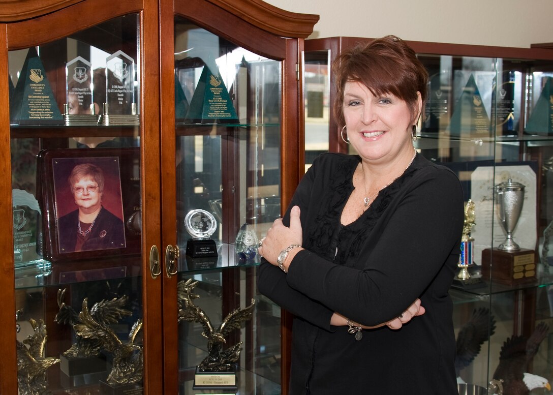 Renee Gifford, 82nd Contracting Squadron program flight chief of plans, stands next to a photo of the late Tandy Weaver, former business operations director for the 82nd CONS Nov. 30, 2012, after being named the 2012 AETC Tandy Weaver Memorial Award winner. The award recognizes individuals who have demonstrated outreach to local small businesses for performing the Air Force mission at their installation. (U.S. Air Force photo/Danny Webb) 