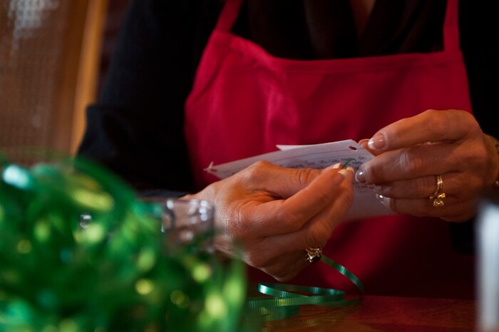 Spouses of Nellis leaders put together Christmas cards to attach to the cookie platters left for Airmen during the 2012 Holiday Cookie Drive Dec. 03, 2012, at Nellis Air Force Base, Nev. People wishing to donate cookies to the drive can drop off their baked goods at the Nellis AFB Chapel on Dec. 11 from 6 - 9 a.m. and at Creech on Dec. 10 from 7:30 a.m. - 4:30 p.m. (U.S. Air Force by Senior Airman Daniel Hughes)