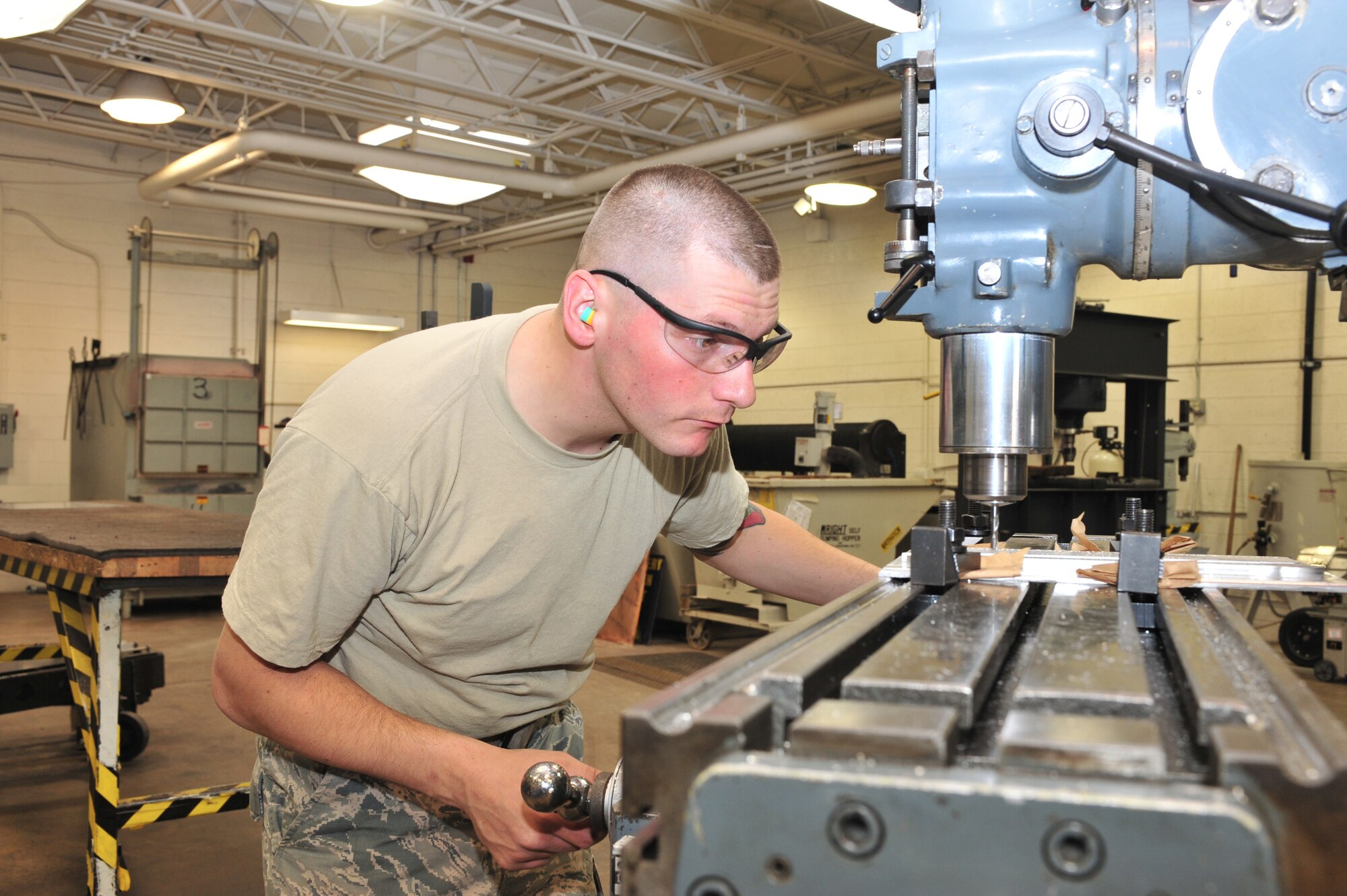 U.S. Air Force Airman 1st Class Donovan Timek, 355th Equipment Maintenance Squadron aircraft metals technology journeyman, is pocket milling on Davis-Monthan Air Force Base, Ariz., Nov 29, 2012. Pocket milling is removing all the material inside some arbitrary closed boundary on a flat surface of a work piece to a fixed depth (U.S. Air Force Photo by Airman 1st Class Josh Slavin/Released)