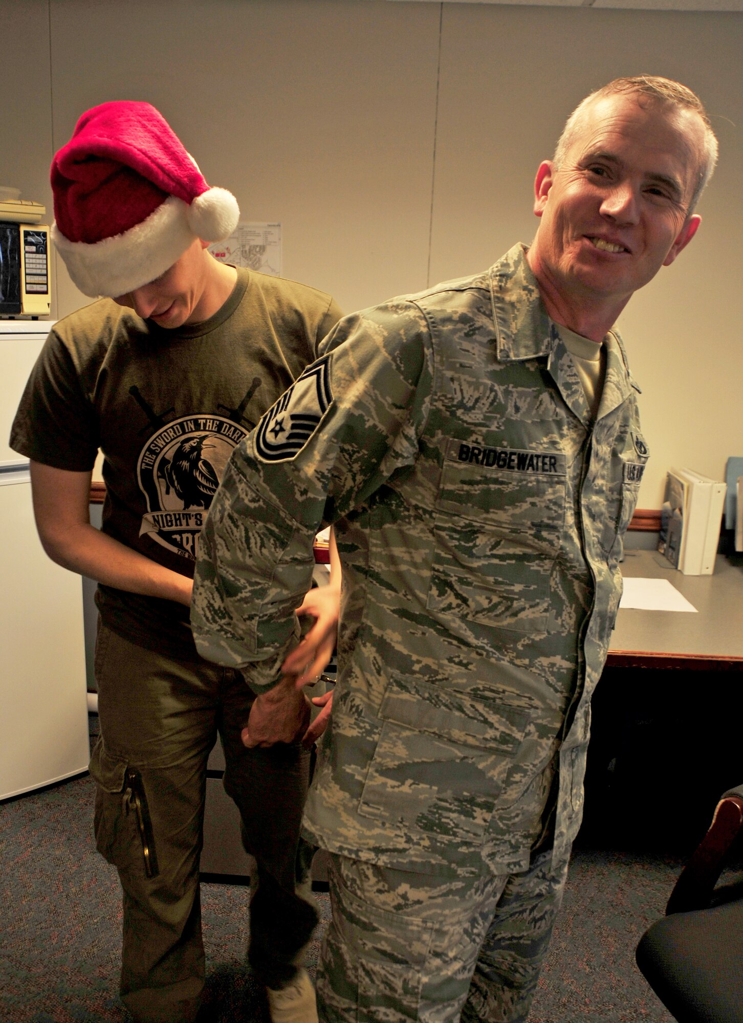 Senior Master Sgt. Bret Bridgewater gets “arrested” during the Operation Santa Lock-up fundraiser at Fairchild Air Force Base, Wash., Nov. 30, 2012. The event was to benefit Operation Warmheart and the Defenders Association. Members of Fairchild called in to put out an “arrest warrant” on their fellow wingman to be put into a simulated jail. The amount of time spent in jail was determined by the amount of money donated to the fundraiser. Bridgewater is the operations superintendent for the 92nd Civil Engineer Squadron.  (U.S. Air Force photo by Airman 1st Class Taylor Curry)