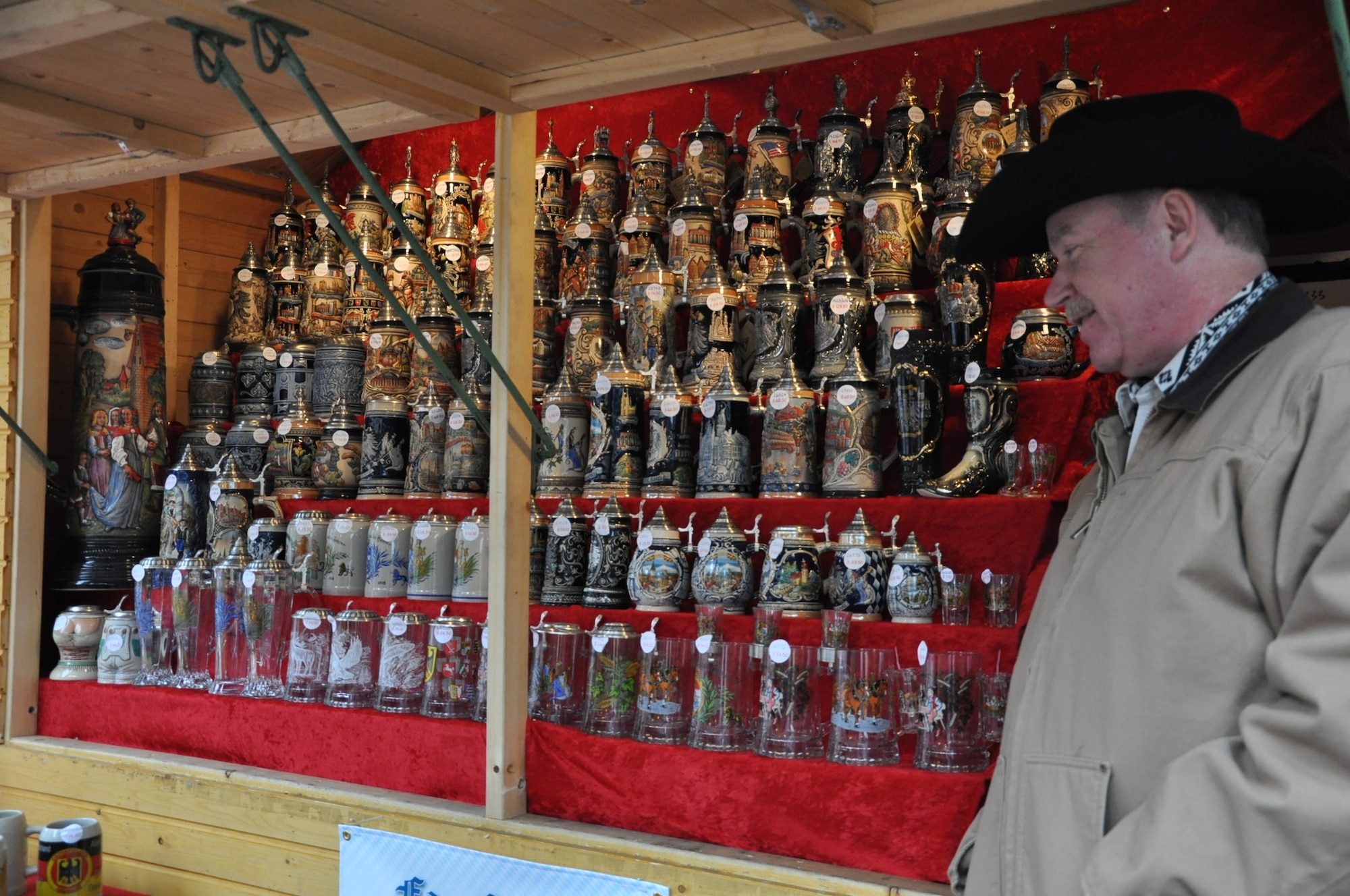 DENVER – A vendor from Germany stands at his booth selling steins Nov. 28, 2012, at the 12th annual Denver Christkindl Market. The market is located on the corners of 16th and Arapahoe Streets in downtown Denver. Numerous vendors from all over the world traveled to the market to share traditions, cuisine and wares. (U.S. Air Force photo by Staff Sgt. Kali L. Gradishar)