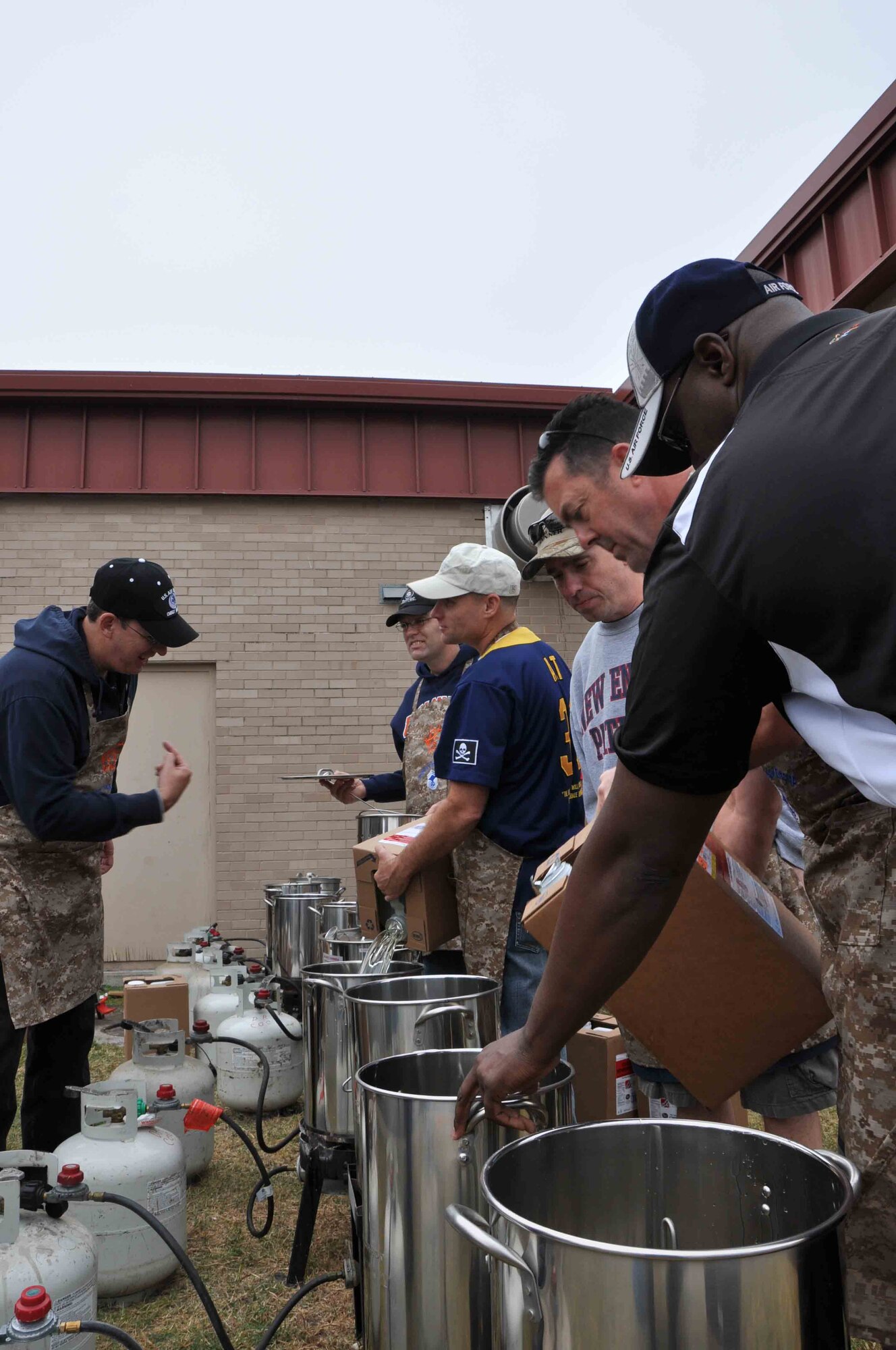 Col. Tom Murphy, 47th Flying Training Wing commander, and Laughlin’s Chief Master Sergeants prepare deep fryers for turkeys at the 23rd Annual Wild Game Dinner Dec. 1, 2012, in Del Rio, Texas. More than 90 volunteers from Laughlin participated in the dinner which is the single biggest fund raiser for Del Rio Chamber of Commerce. (U.S. Air Force photo/2nd Lt. David Tart)   