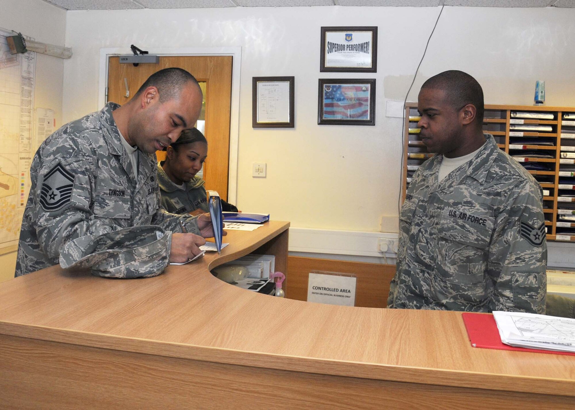 Staff Sgt. Patrick Church, 100th Logistics Readiness Squadron operators’ records and licensing NCO in charge from Jamesville, Va., dispatches a vehicle to Senior Master Sgt. Jener Tiongson, RAF Mildenhall career assistance advisor, Dec. 4, 2012, at RAF Mildenhall, England.  Vehicle Operations provides vital on-time aircrew support.  (U.S Air Force photo by Gina Randall/Released)