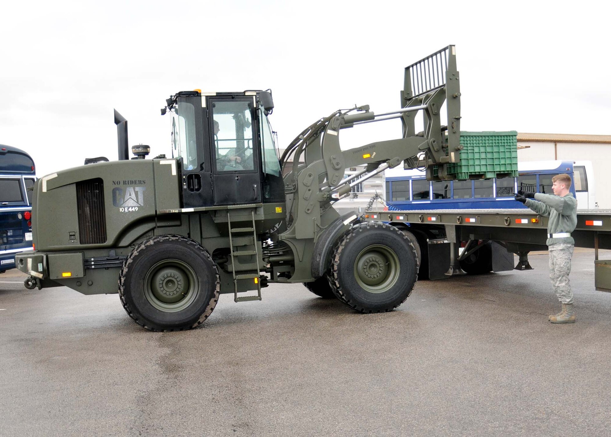 Airman 1st Class Cody Smith, 100th Logistics Readiness Squadron vehicle operator from Macomb, Okla., spots a forklift Dec. 4, 2012, at RAF Mildenhall, England. Forklift spotters ensure safety requirements are met when reversing all vehicles. (U.S Air Force photo by Gina Randall/Released)
