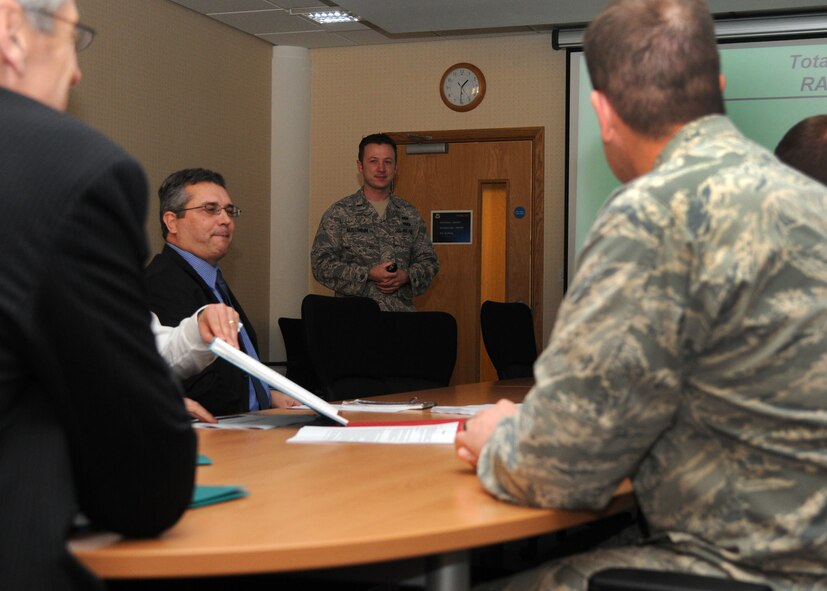 1st Lt. John Nussbaum, 100th Civil Engineer Squadron operations flight commander from Lubbock, Texas, gives a 100th CES mission brief to Steve Rice, Next Generation Contracts program director (left), Dec. 4, 2012, in building 680 at RAF Mildenhall, England. Rice also visited the air traffic control tower and the U.S. Air Forces in Europe U.K. headquarters building. (U.S. Air Force photo by Airman 1st Class Kelsey A.L. Waters/Released)