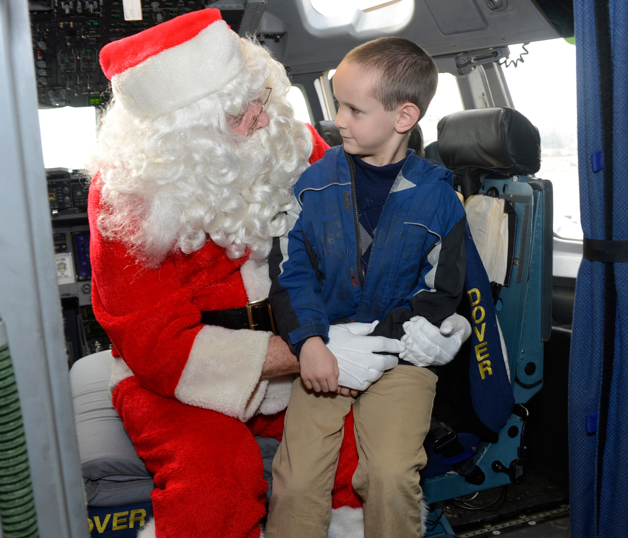 Santa Claus asks Charles Walker, Jr. what he wants for Christmas inside a C-17 Globemaster III Dec. 2, 2012, on the flightline at Dover Air Force Base, Del. Team Dover children had the opportunity to visit with Santa on a C-17, a program sponsored by the Airman and Family Readiness Center. (U.S. Air Force photo by Tech. Sgt. Chuck Walker)