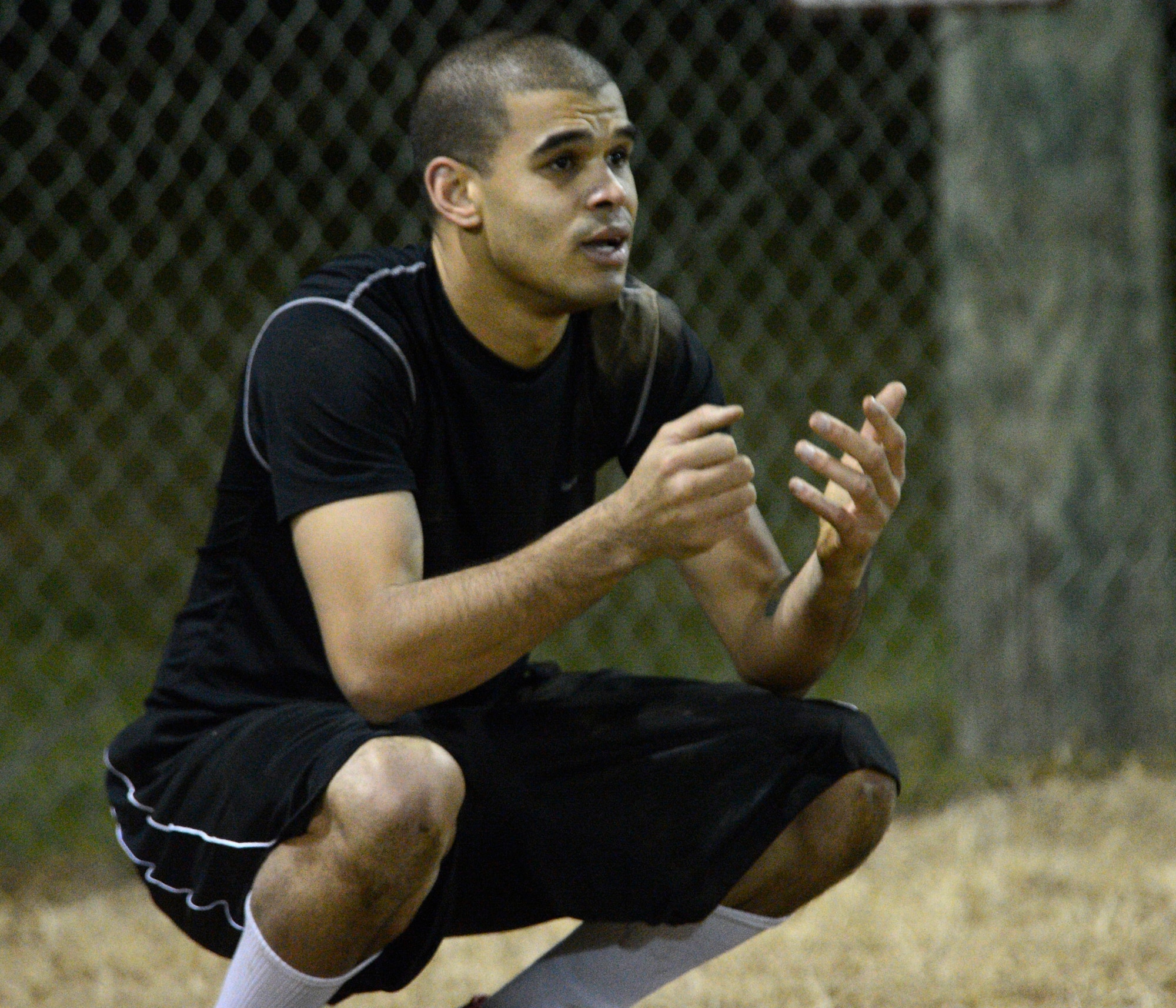 Terrance McCormack, 436th Medical Group quarterback, squats on the sidelines during the flag football championship game against the 436th Civil Engineer Squadron Nov. 30, 2012, at the softball field on Dover Air Force Base, Del. McCormack was upset after he was sacked on 4th down giving the ball back to the 436th CES. The 436th CES won the championship 27-19. (U.S. Air Force photo by Tech. Sgt. Chuck Walker)