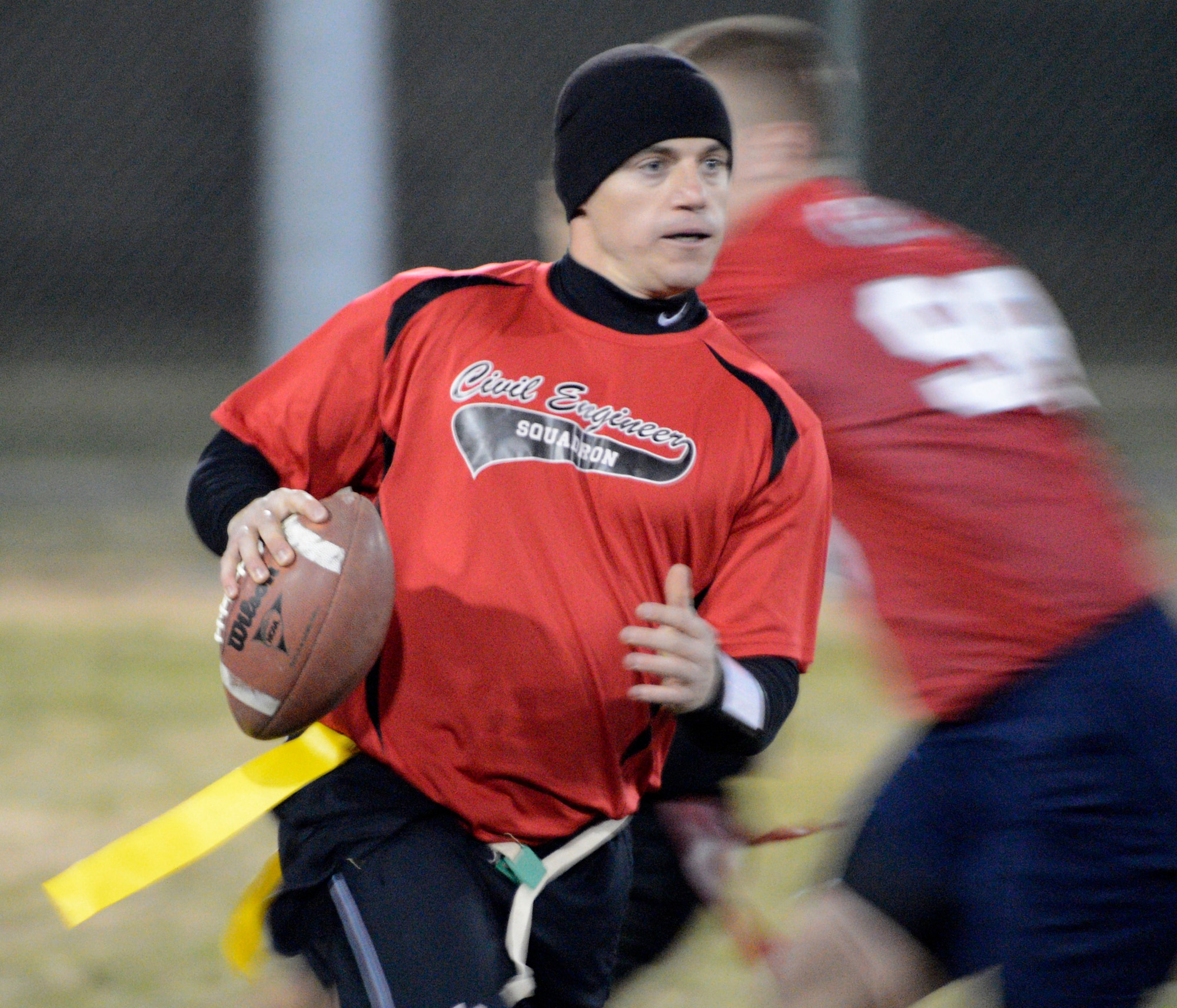 Steven Peaper, quarterback for the 436th Civil Engineer Squadron, runs for a first down during the flag football championship game against the 436th Medical Group Nov. 30, 2012, at the softball field on Dover Air Force Base, Del. The 436th CES won the championship defeating the 436th MDG 27-19. (U.S. Air Force photo by Tech. Sgt. Chuck Walker)