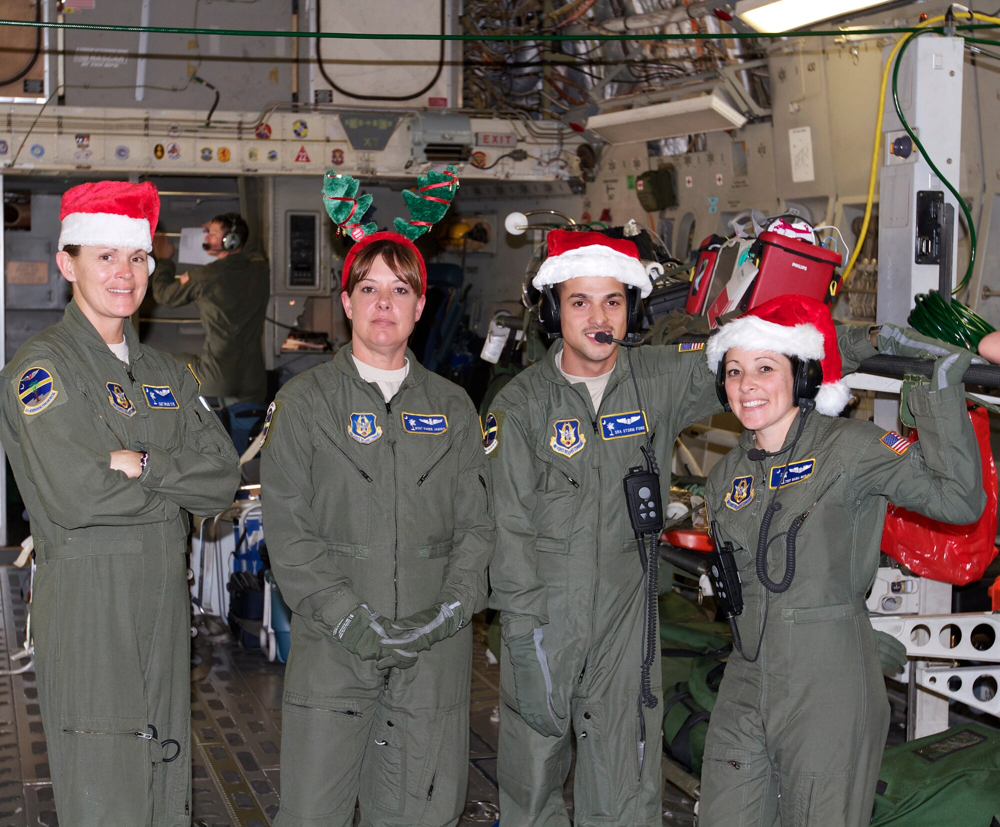 'It's beginning to look a lot like Christmas!' The 315th Aeromedical Evacuation Squadron's (from left) Staff Sgt. Brigid Dye, Master Sgt. Karen Jagoda, Senior Airman Storm Ford, and Tech Sgt. Maria Wesloh show a little holiday spirit during a recent 315th Airlift Wing Mission. (U.S. Air Force Photo / Senior Master Sgt. Dean Carter)