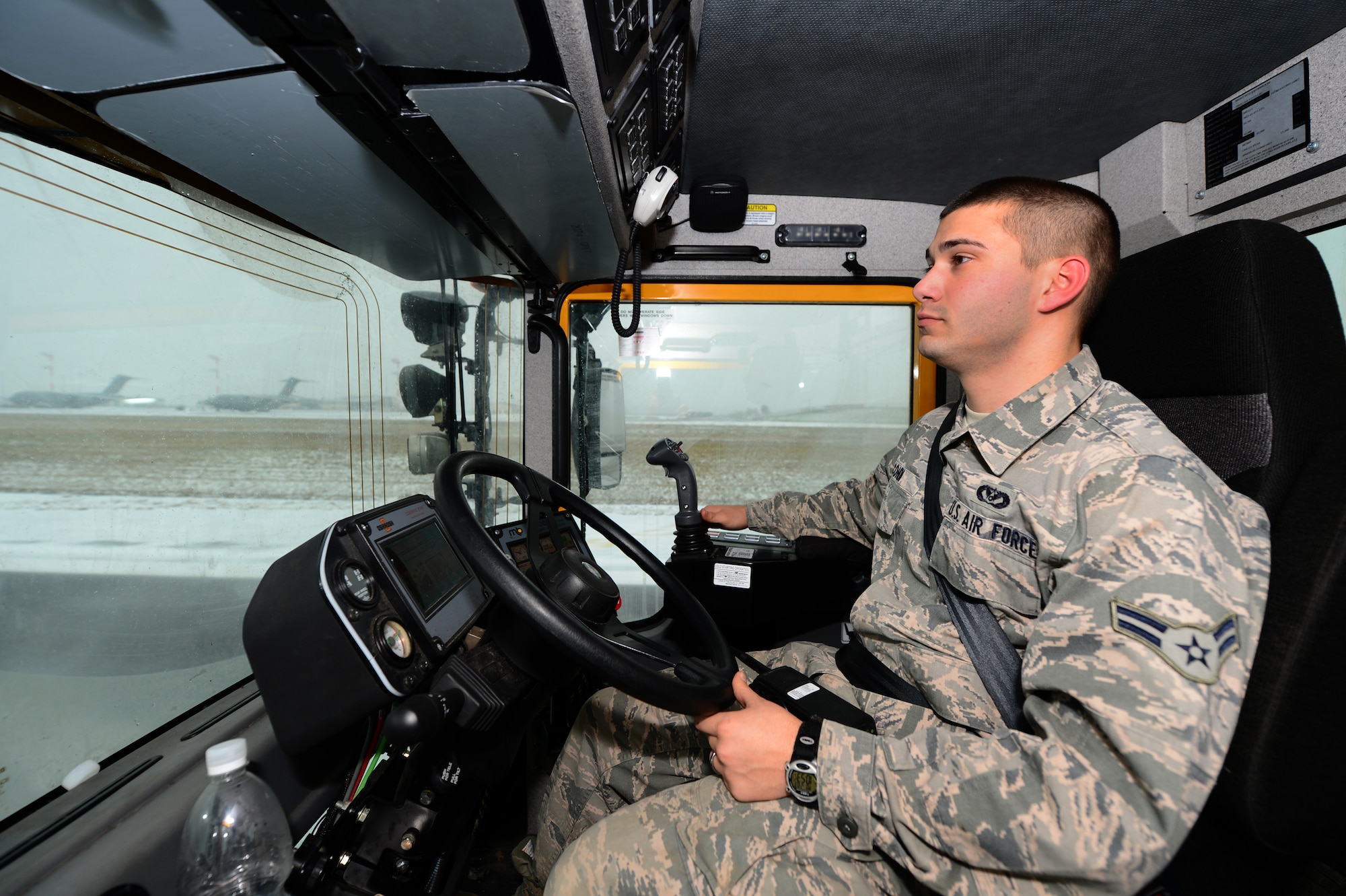 SPANGDAHLEM AIR BASE, Germany – U.S. Air Force Airman 1st Class Richard Cohen, 52nd Civil Engineer Squadron snow removal augmentee from Bridgeport, W.Va., drives a snow broom vehicle on the flight line Dec. 3, 2012. The pavement maintenance and heavy vehicle shop is responsible for maintaining and clearing the airfield, base roads and sidewalks on Spangdahlem AB and Bitburg Annex. (U.S. Air Force photo by Airman 1st Class Dillon Davis/Released)