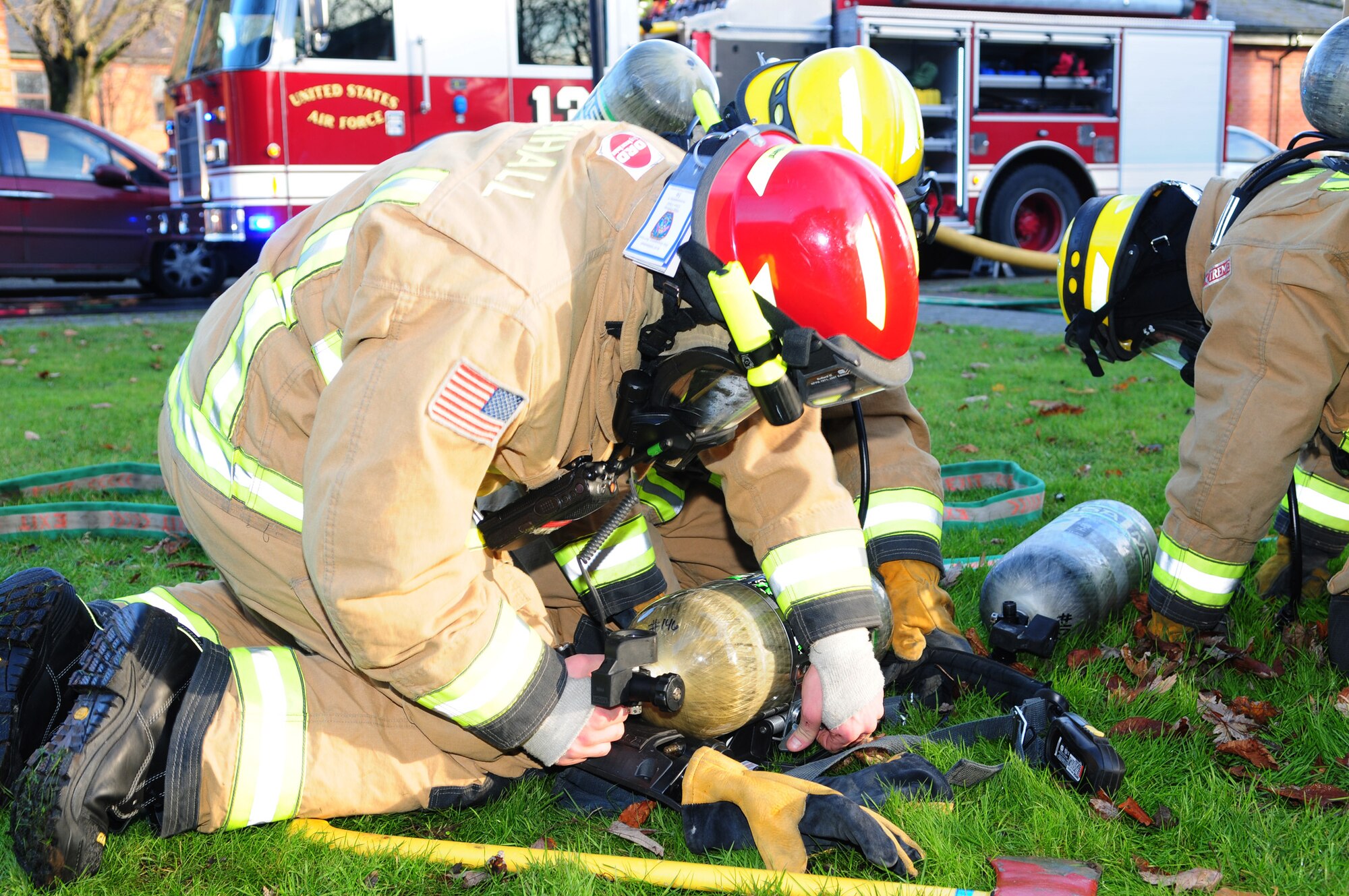 Firefighters replace their oxygen bottles after responding to a smoke-filled building Dec. 3, 2012, during an operational readiness exercise at RAF Mildenhall, England. The ORE, which runs to Dec. 7, is one of many in preparation for a combined unit inspection in 2013. (U.S. Air Force photo by Karen Abeyasekere/Released)