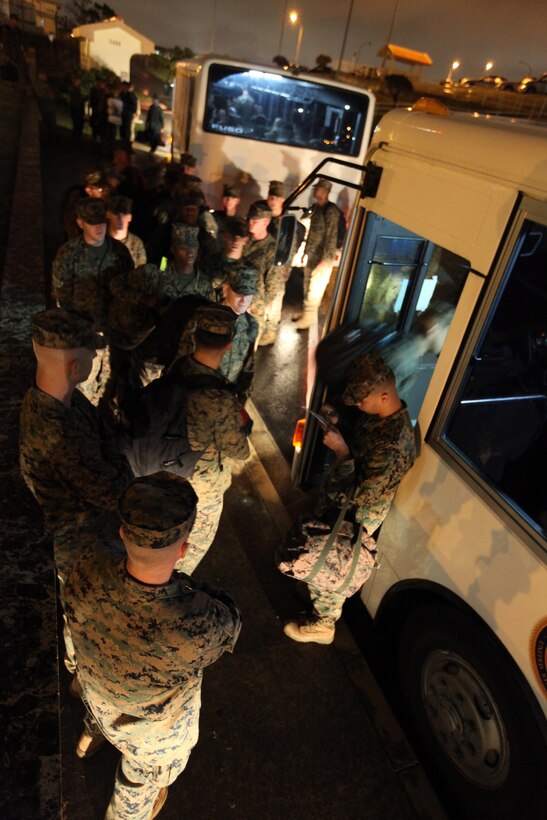 Marines and Sailors with 1st Battalion, 5th Marine Regiment, take accountability while boarding buses here, Dec.2, after arriving to assume their role as the 31st Marine Expeditionary Unit's Battalion Landing Team. “The Professionals" of 2nd Battalion, 1st Marine Regiment, are being replaced by members of “The Old Breed” to begin training for the 31st MEU's spring deployment.