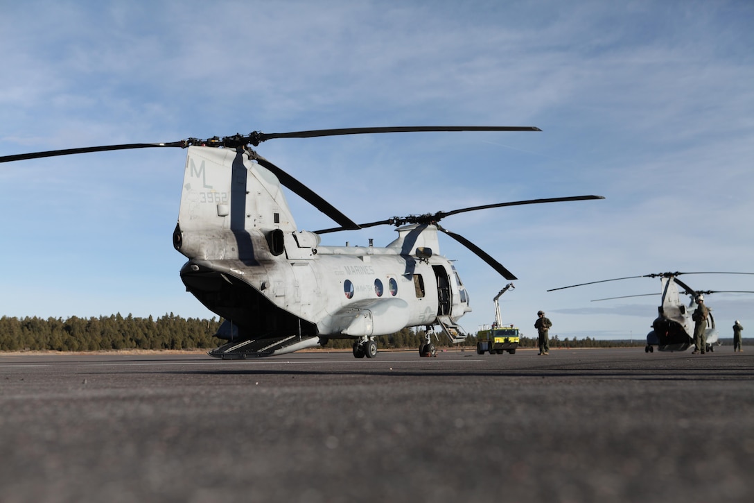 Crew chiefs with Marine Medium Helicopter Squadron (HMM) 764 prepare to fly Marines and volunteers with Flagstaff Marine League Charities and Flagstaff Toys for Tots to the floor of the Grand Canyon Dec. 4, 2012 at the Grand Canyon National Park Airport. The volunteers gathered toys and supplies to deliver to members of the Havasupai tribe, the most isolated tribe in America via CH-46E Sea Knight helicopters. (U.S. Marine Corps photo by Cpl. Jessica Ito/Released)