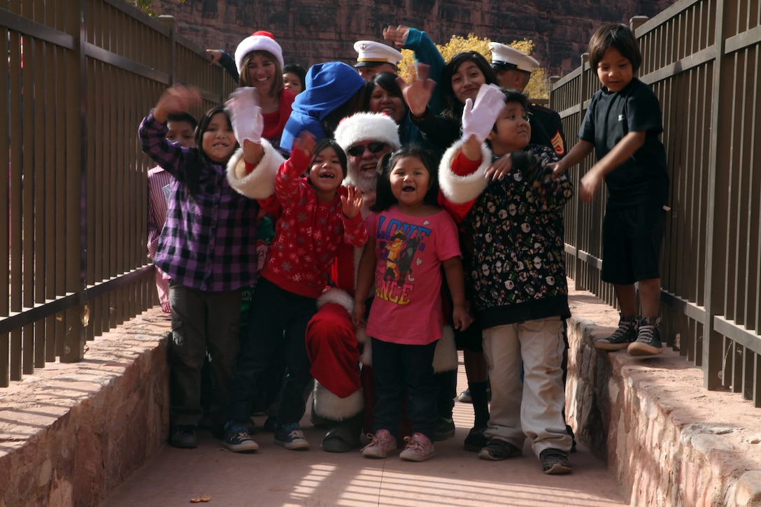 Children of the Havasupai tribe gather around Santa after he arrives in the Grand Canyon Dec. 4, 2012 in Supai, Ariz. After Santa’s arrival, Marines from Environmental Services Division helped him pass out toys gathered by volunteers of the Flagstaff Marine League Charities and the Flagstaff Toys for Tots organization to more than 175 children. (U.S. Marine Corps photo by Cpl. Jessica Ito/Released)