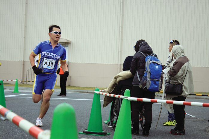 A Heat the Streets 2012 Duathlon compeititor runs toward the finish line for the race in front of the IronWorks Gym here, Dec. 2, 2012. The duathlon consisted of a 4.5 kilometer run, a 28 kilometer bike course, then a final 4.5 kilometer run.