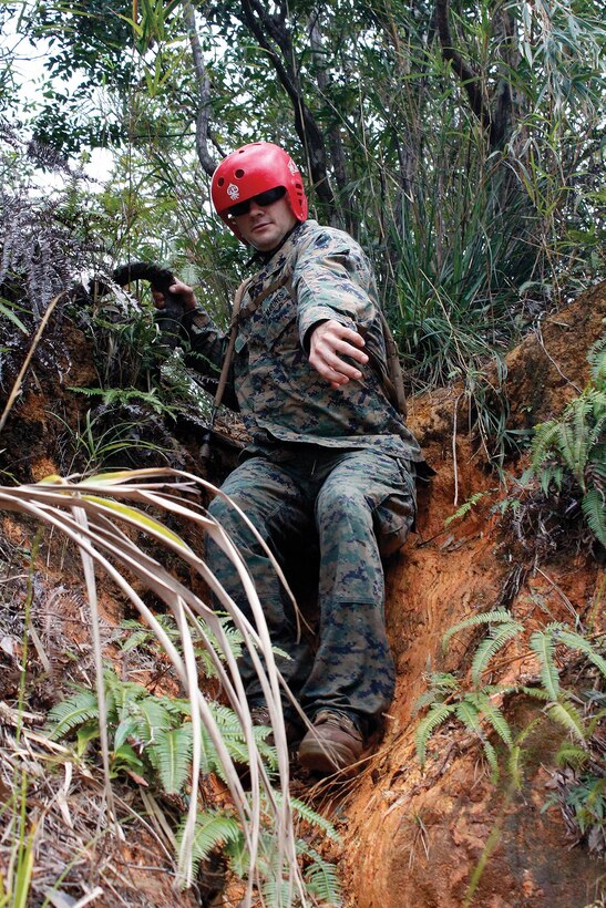 Sgt. Justin D. Lofay, with Headquarters and Service Battalion’s corporals course, climbs down a steep hill to reach his squad’s next point during the land navigation course at the Jungle Warfare Training Center Nov. 28. Land navigation is a perishable skill that requires consistent training in various environments, according to Cpl. Christopher M. Becker, an instructor with the Jungle Warfare Training Center. Lofay is an instructor with the course and an automotive maintenance technician with Combat Logistics Regiment 35, 3rd Marine Logistics Group, III Marine Expeditionary Force. 
