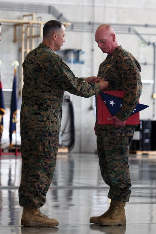 Maj. Gen. Peter J. Talleri, left, awards Col. John C. Wright the Legion of Merit during his retirement ceremony at Marine Corps Air Station Futenma Nov. 29. Wright will continue to serve as the chief of staff for Marine Corps Installations Pacific after retiring from active-duty. 