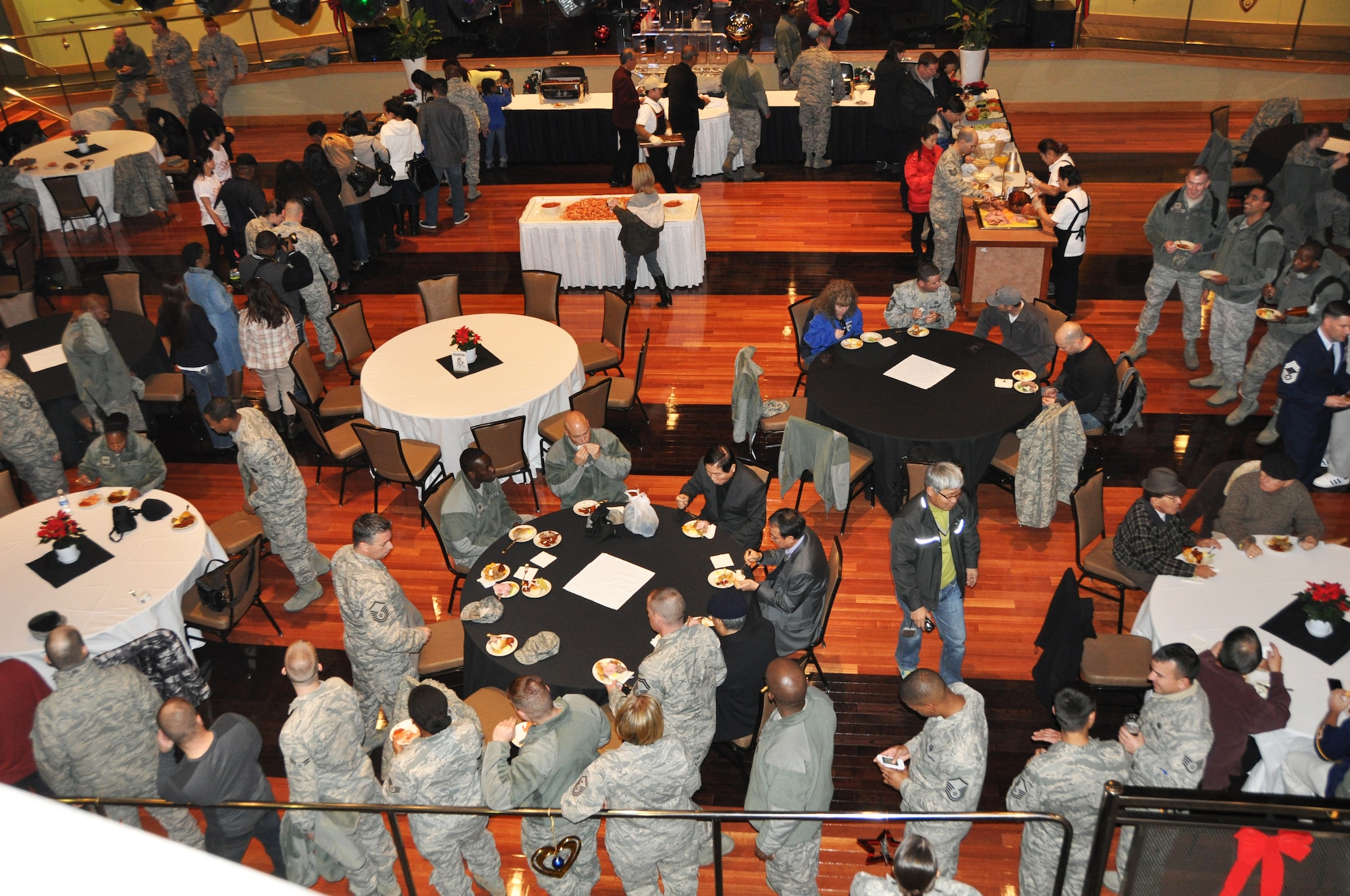 Members of Team Osan gather in the ballroom of the new enlisted club after the grand opening ceremony Nov. 30, 2012. The event began with a ribbon cutting ceremony, and featured live music, karaoke, games and giveaways. (U.S. Air Force photo/Senior Airman Kristina Overton)