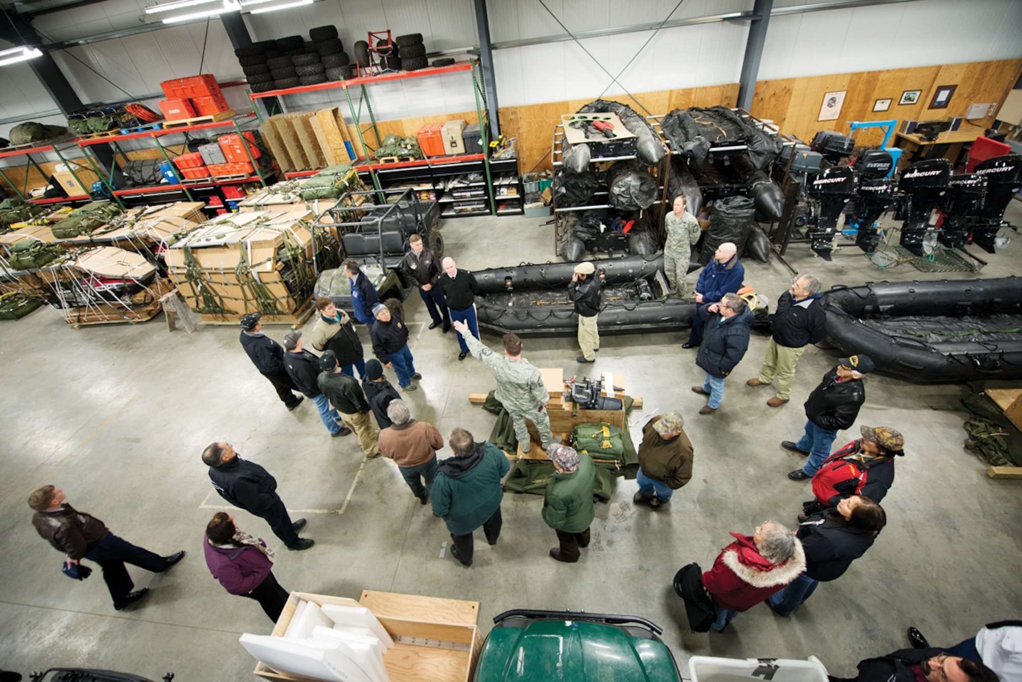 Tribal leaders and their military hosts for the Tribal Leaders and Military Leaders Meeting VI, held at Joint Base Elmendorf-Richardson, receive a briefing on the equipment and capabilities of the 212th Rescue Squadron from Senior Master Sgt. Christopher “Doug” Widener, operations superintendent. The meeting was held here Nov. 27.  (U.S. Air Force Photo/Airman 1st Class Omari Bernard)