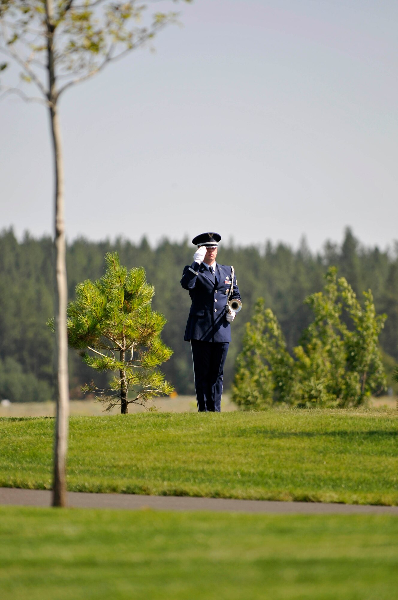 Staff Sgt. Richard Hatch, 141st Air Refueling Wing band member, renders a salute during a ceremony at the Washington State Veterans Cemetery, Medical Lake Washington, July 30, 2012. (U.S. Air Force photo by Master Sgt. Michael Stewart/Released)