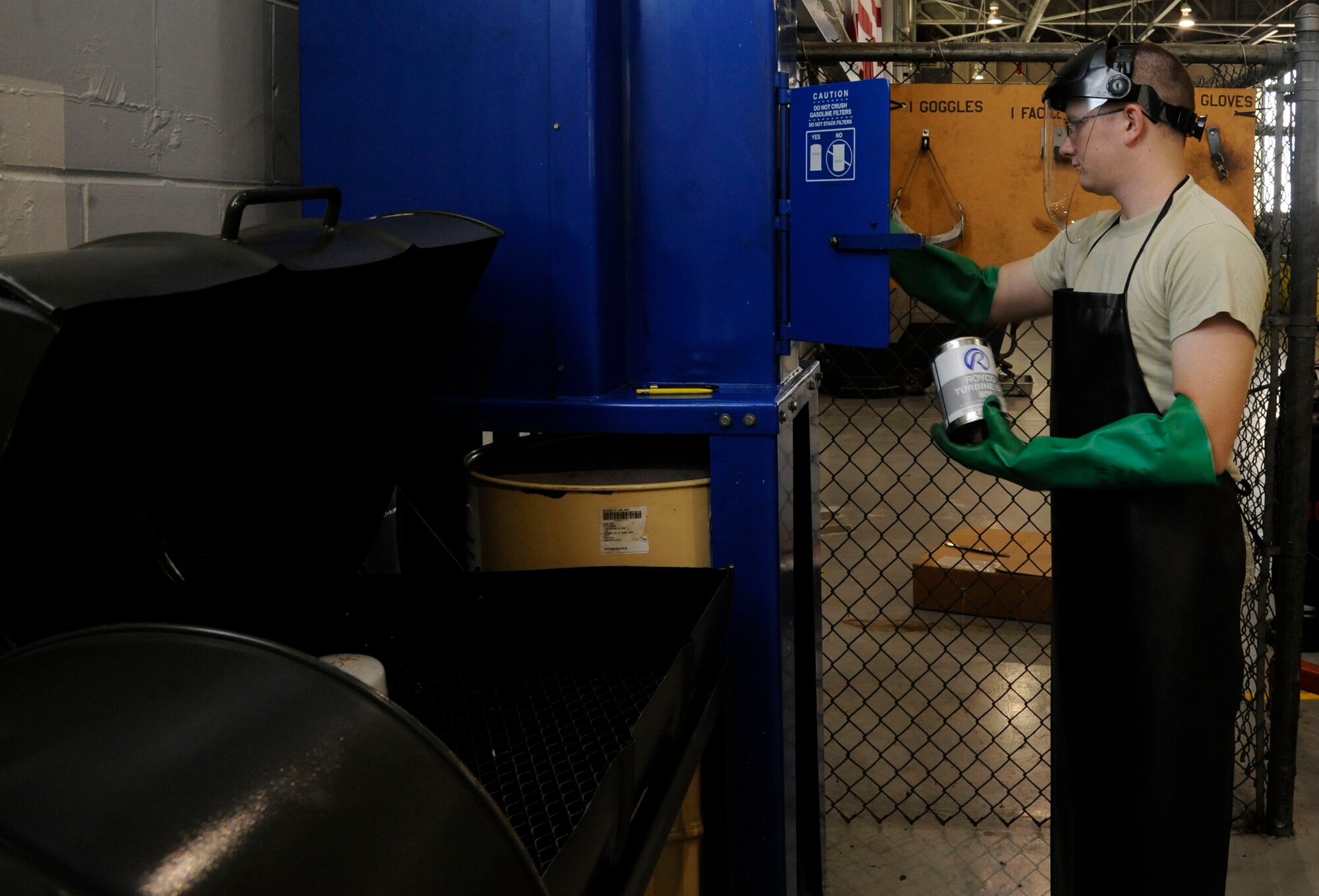 Staff Sgt. Cameron Cofer, 2nd Maintenance Squadron Aerospace Ground Equipment Flight production control section, crushes used oil filters on Barksdale Air Force Base, La., Dec. 4. The production control section is accountable for more than 600 pieces of AGE, worth more than $22 million, and procuring all equipment the flight needs to complete its mission. (U.S. Air Force photo/Airman 1st Class Andrew Moua)(RELEASED)